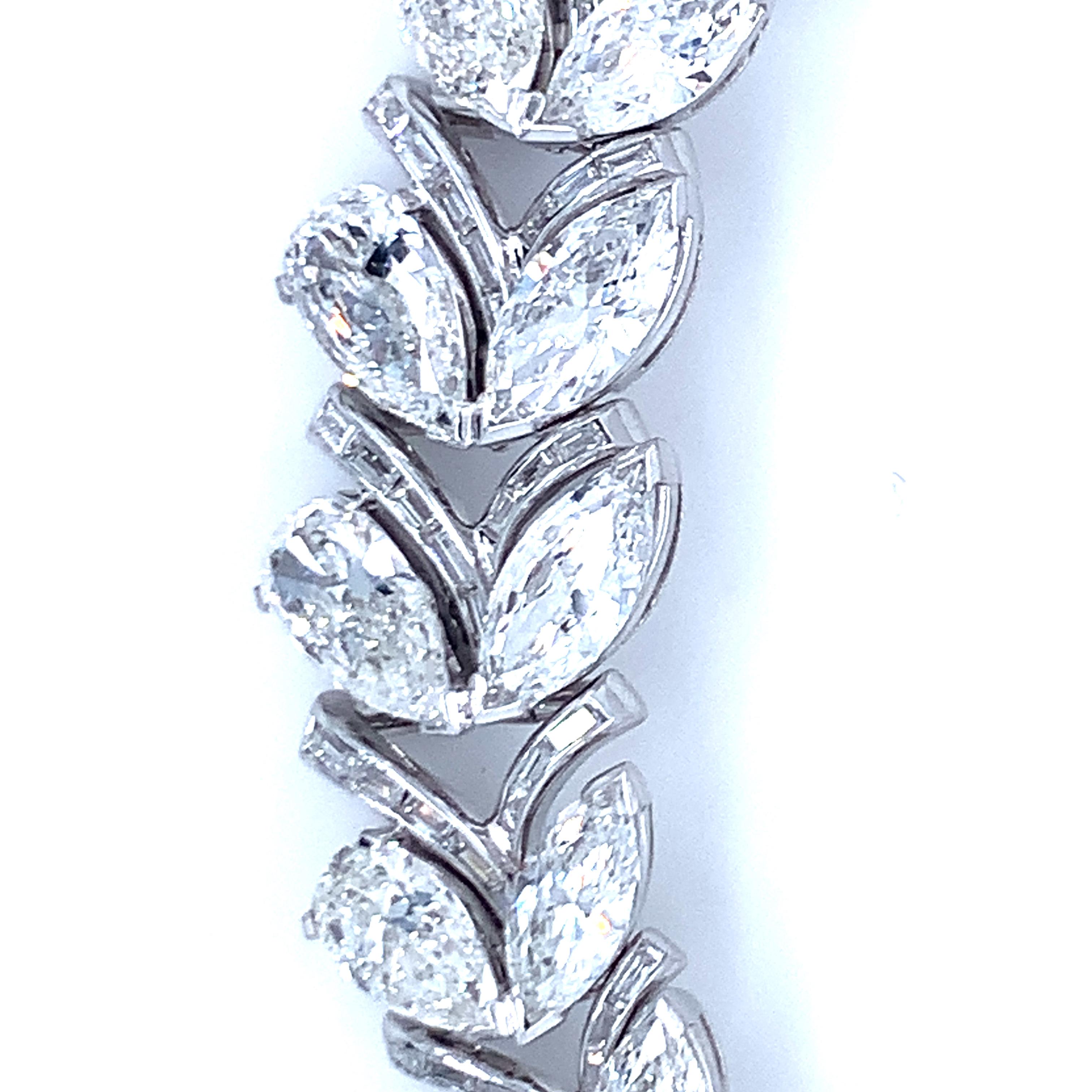One mid-century diamond necklace set in platinum featuring 324 marquise, pear and straight baguette diamonds with an approximate total weight of 48 ct., H-I-J / VS-2, SI-1. 18 of the stones at over 1 ct. positioned at center of necklace as it tapers