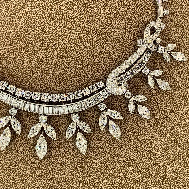 A platinum mid-century treasure from the 1950's this magnificent necklace features approximately 40 carats of VS clarity F-G color diamonds. From round and baguette cuts on the clasp and running down the necklace to larger marquise cuts (some over 1