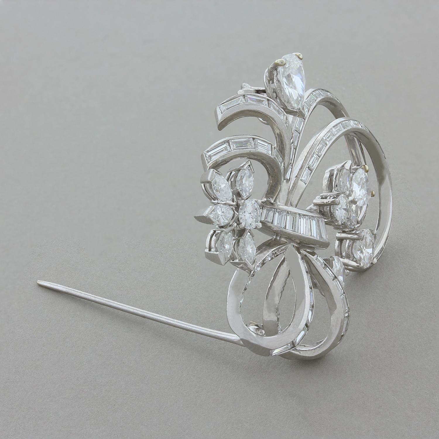 A beautiful platinum brooch from the 1950’s featuring 6.00 carats of diamond, including round and baguette cuts that create loops and curves around the piece. They are accented my larger sized marquise, pear and round cut diamonds that are clustered