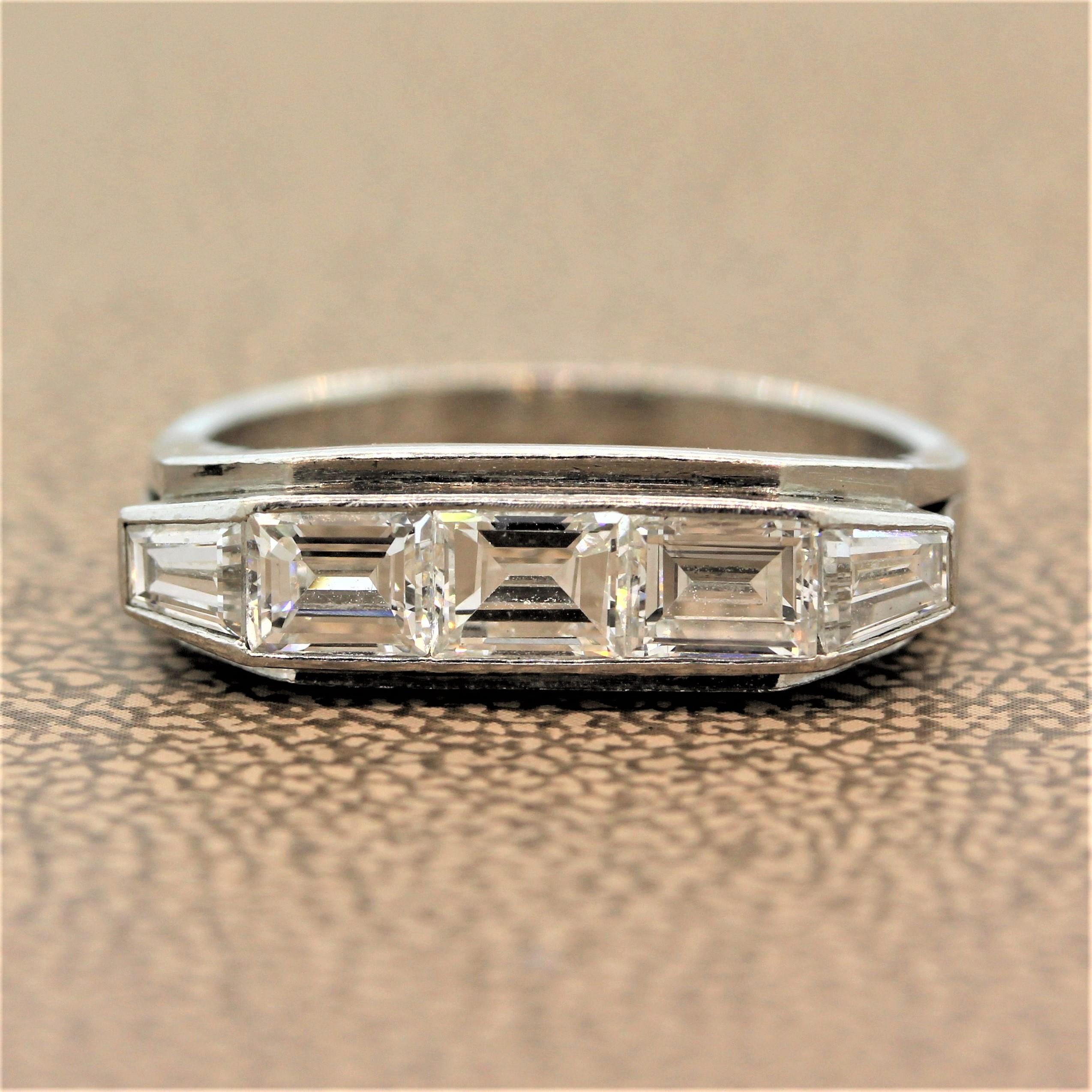An unassuming mid-century treasure. This everyday ring features a flat top with 1.37 carats of baguette cut diamonds in a hand fabricated platinum setting with a tapered baguette cut diamond at each end.   

Ring Size 6.75 (Sizable)
