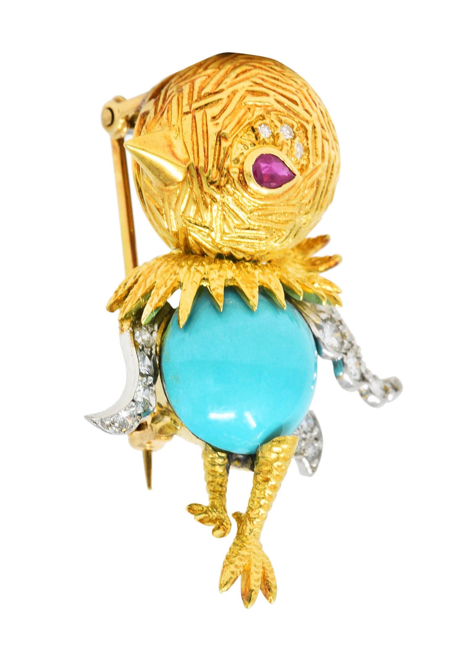 Brooch is designed as a stylized cartoon-like bird with texturous head and legs. Featuring a round turquoise cabochon body measuring 12.0 x 12.0 mm. Opaque light blue in color with subtle light mottling - set by wings and legs. With platinum wings