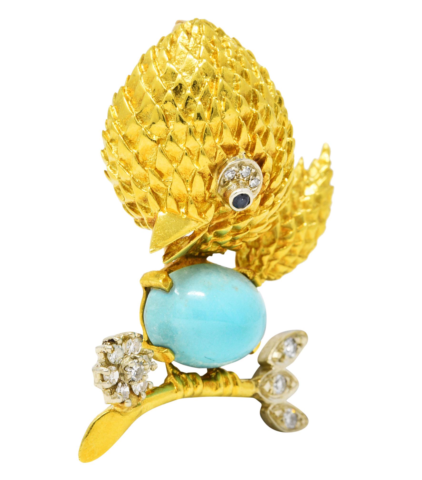 Brooch is designed as a stylized cartoon bird perched on a branch with a texturous head and tail. Featuring a bullet shaped turquoise cabochon body measuring 9.0 x 13.0 mm. Opaque light blue in color with subtle tan matrix - prong set east to west.