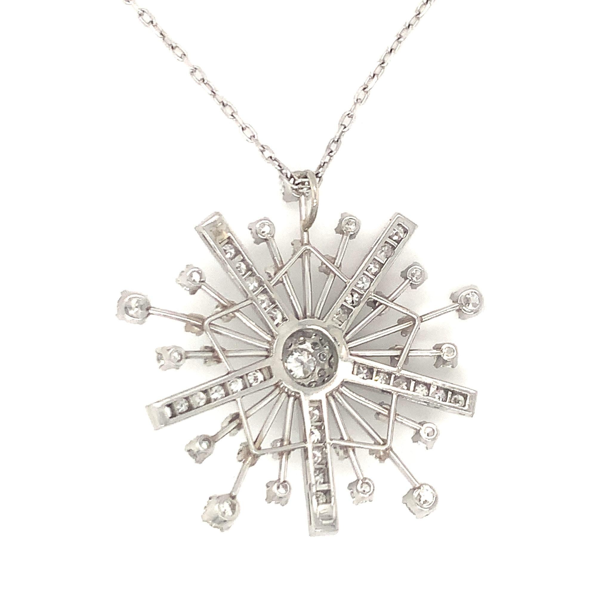 One mid-century diamond snowflake motif platinum pendant featuring 81 old European cut and single round cut diamonds totaling 2.55 ct. Measuring 38 millimeters in diameter, and set upon a platinum open link chain necklace. Circa 1950s.

Dazzling,