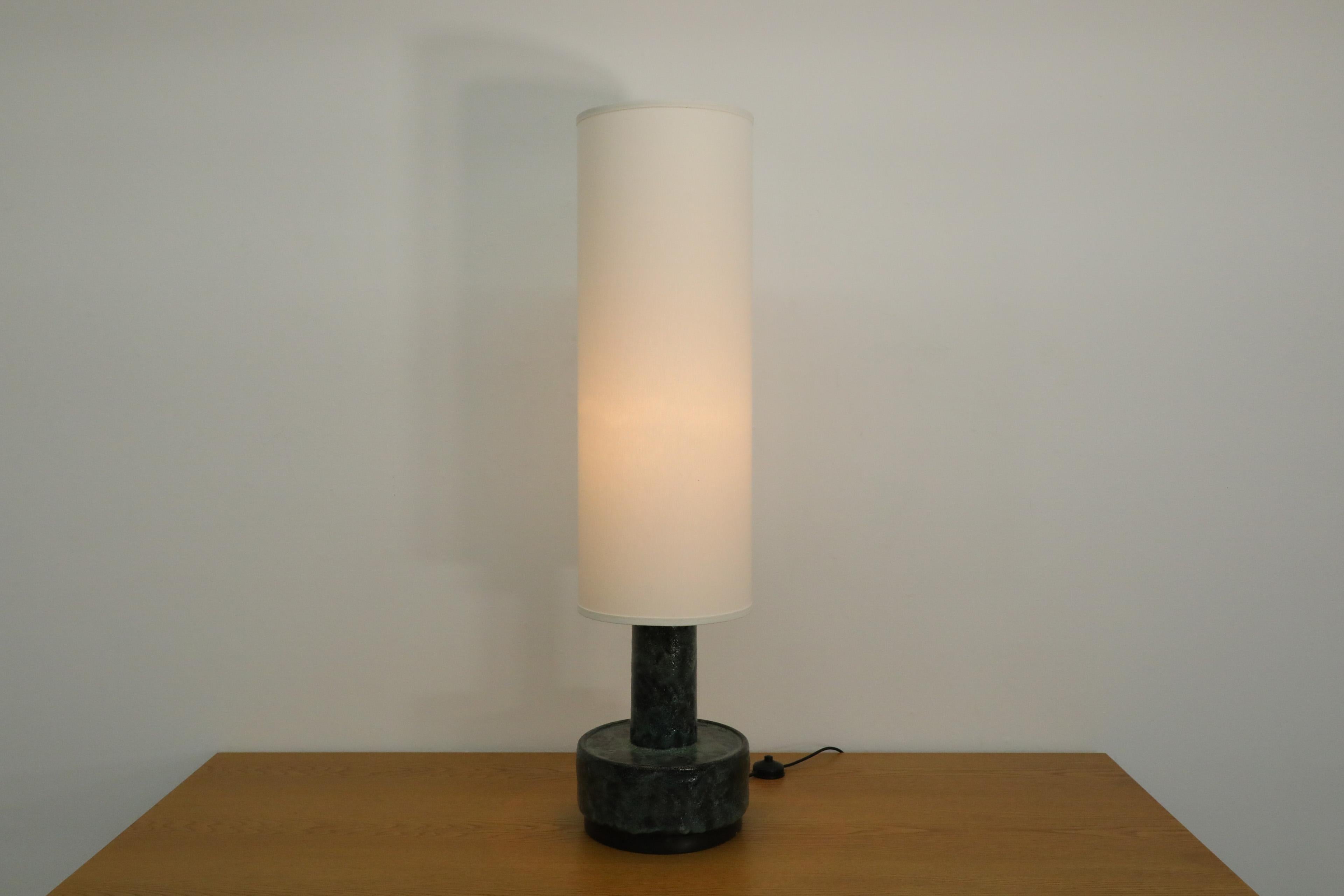 Mid-Century Dijkstra Lampen ceramic table or floor lamp with newer tall cylinder linen shade. Stunning blue green ceramic glazed surface, with metal rimmed base. Takes standard medium base E26/E27 bulb. In original condition with visible wear