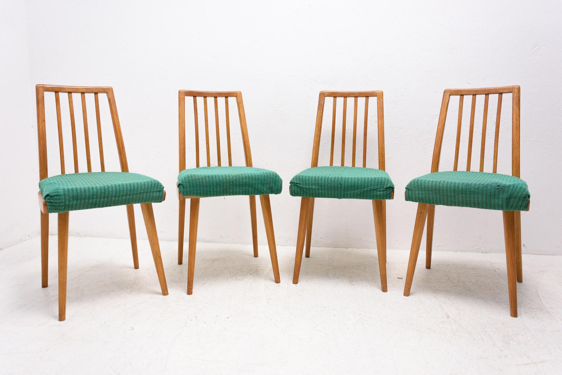 Set of four upholstered dining chairs, made in the former Czechoslovakia in the 1960s. The chairs are constructed of beech wood. Very interesting shaping. The upholstery and wood are in good Vintage condition, shows slight signs of age and using.