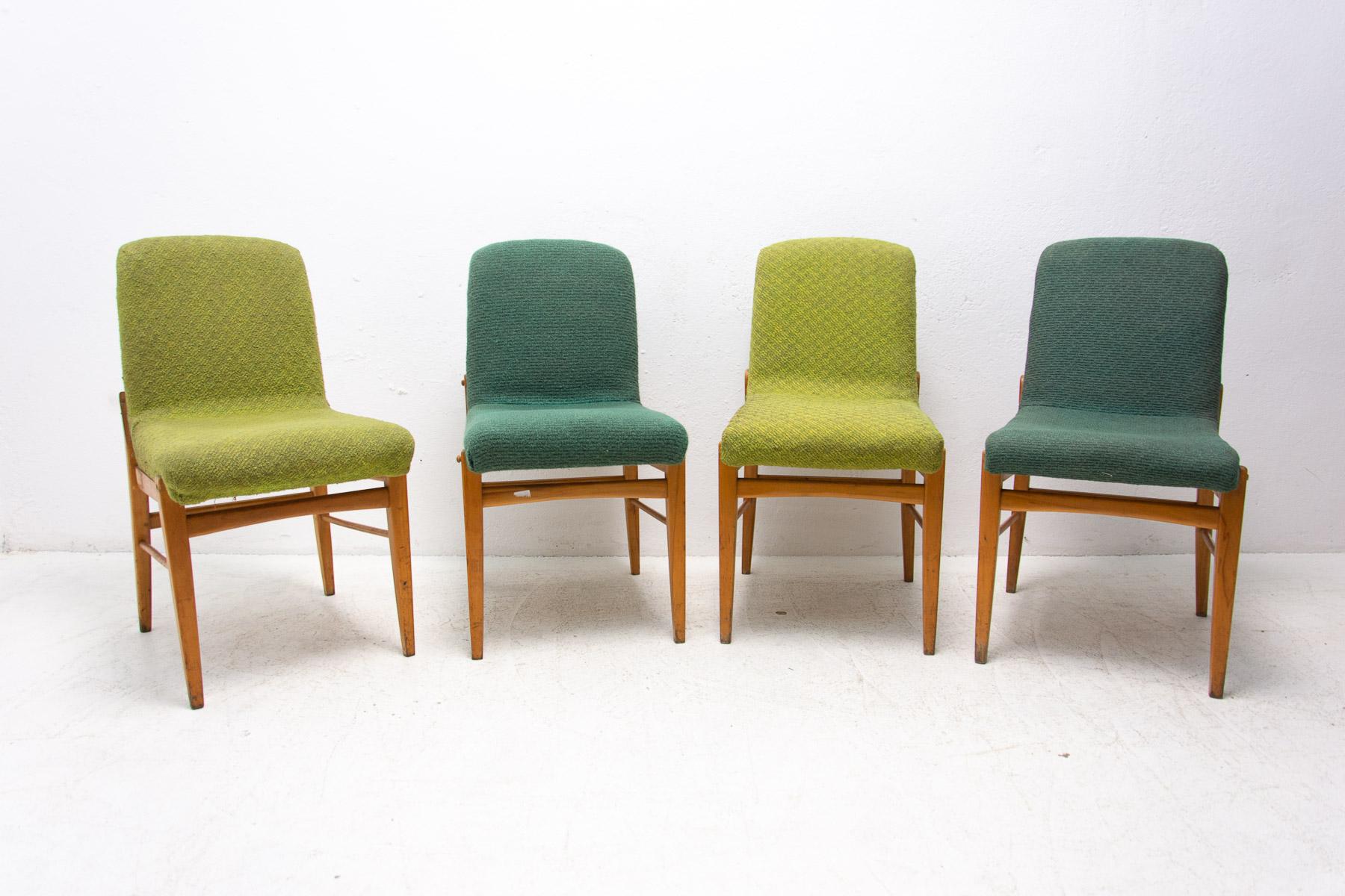 Set of four upholstered dining chairs by Miroslav Navrátil, made in the former Czechoslovakia in the 1960s. The chairs are constructed of beech wood. Very interesting shaping. The chairs are structurally in good condition, the upholstery shows signs