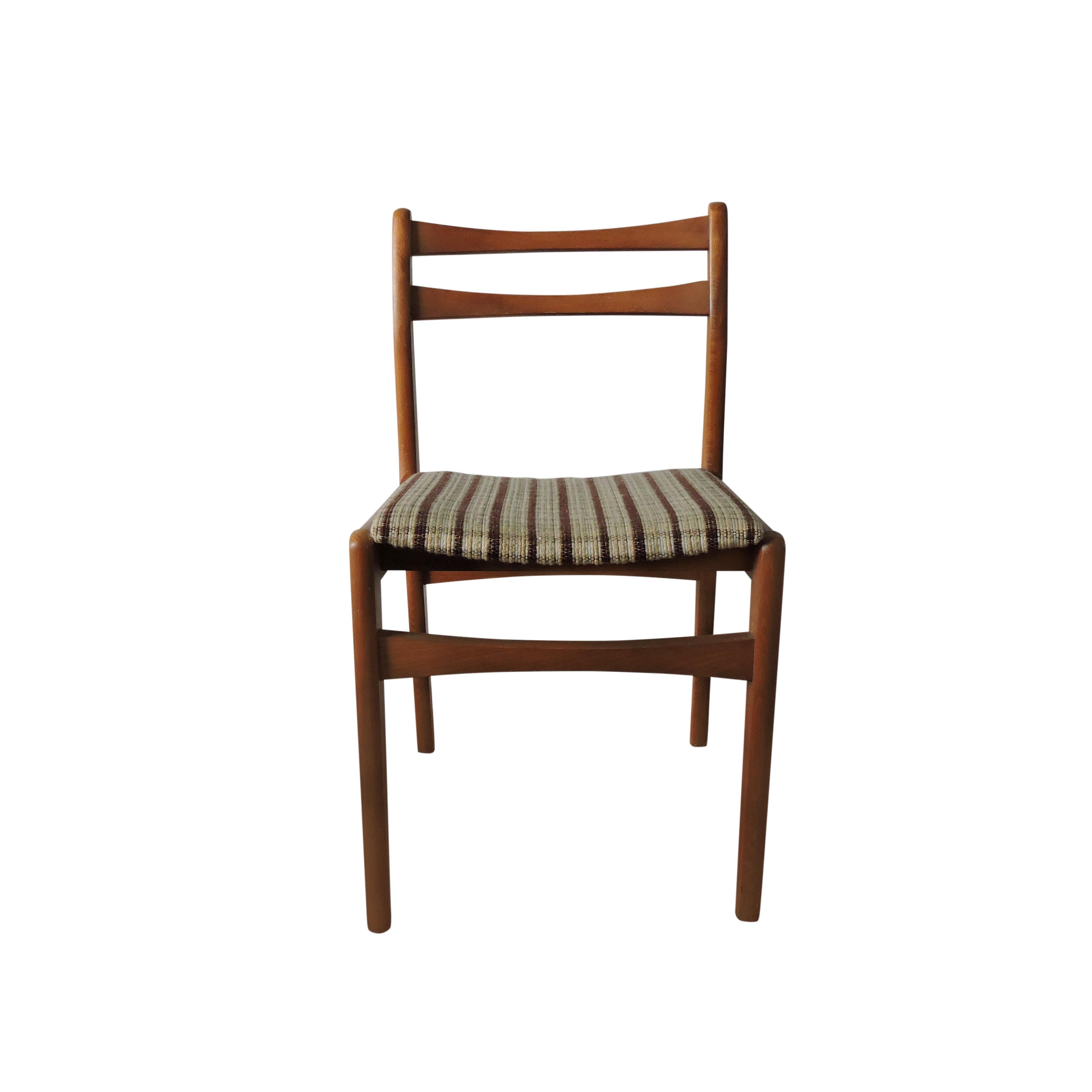 A set of four 1970s teak and upholstered midcentury dining chairs.