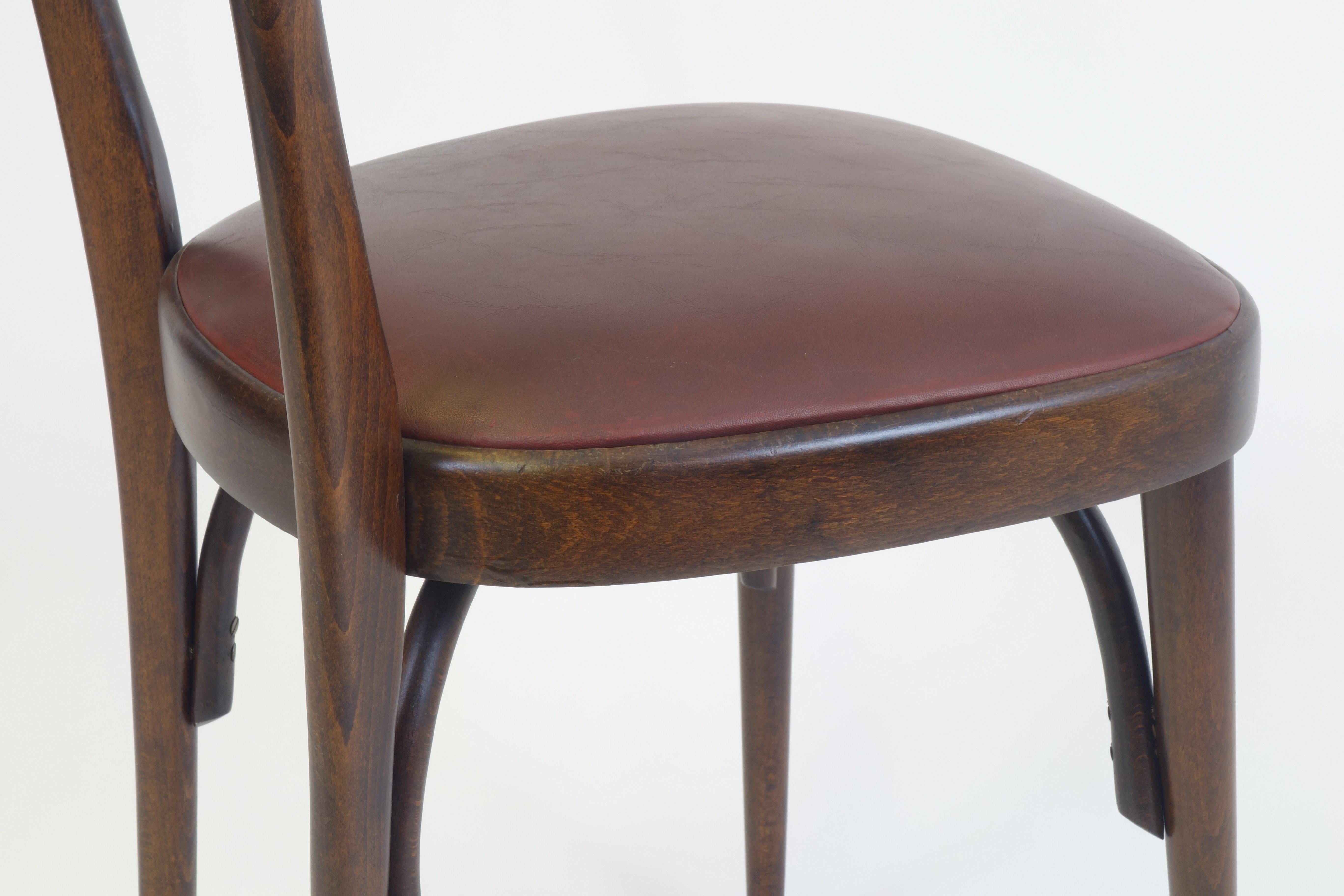 4 smart dining chairs conveying the understated eccentric mood of the famous Italian Cantú-style, very reminiscent of the design by Ico Parisi. These remarkable objects are in their original pure and unrestored condition still with the original