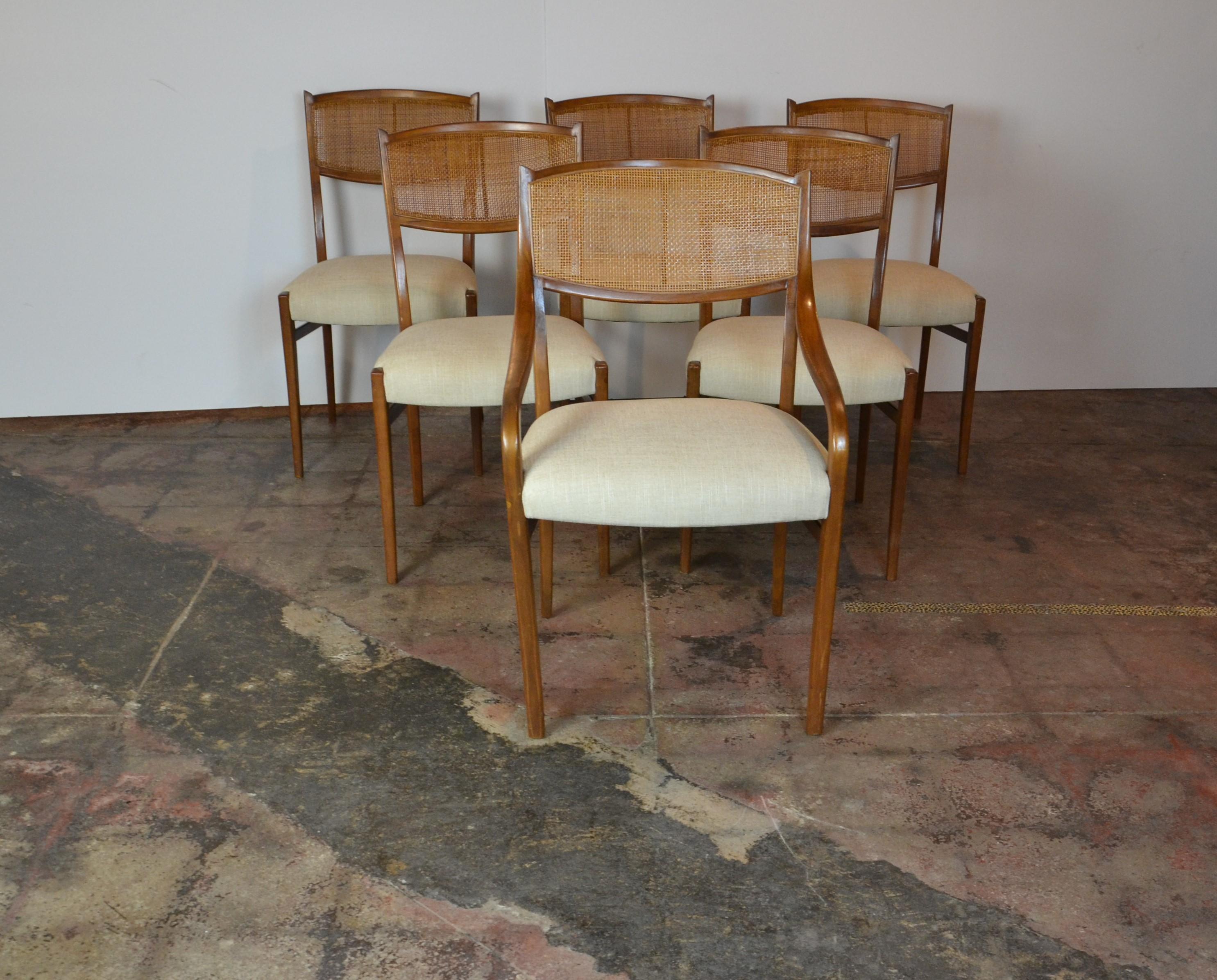 Midcentury dining chairs with cane back. Newly upholstered. Measures: Armchair 21.50