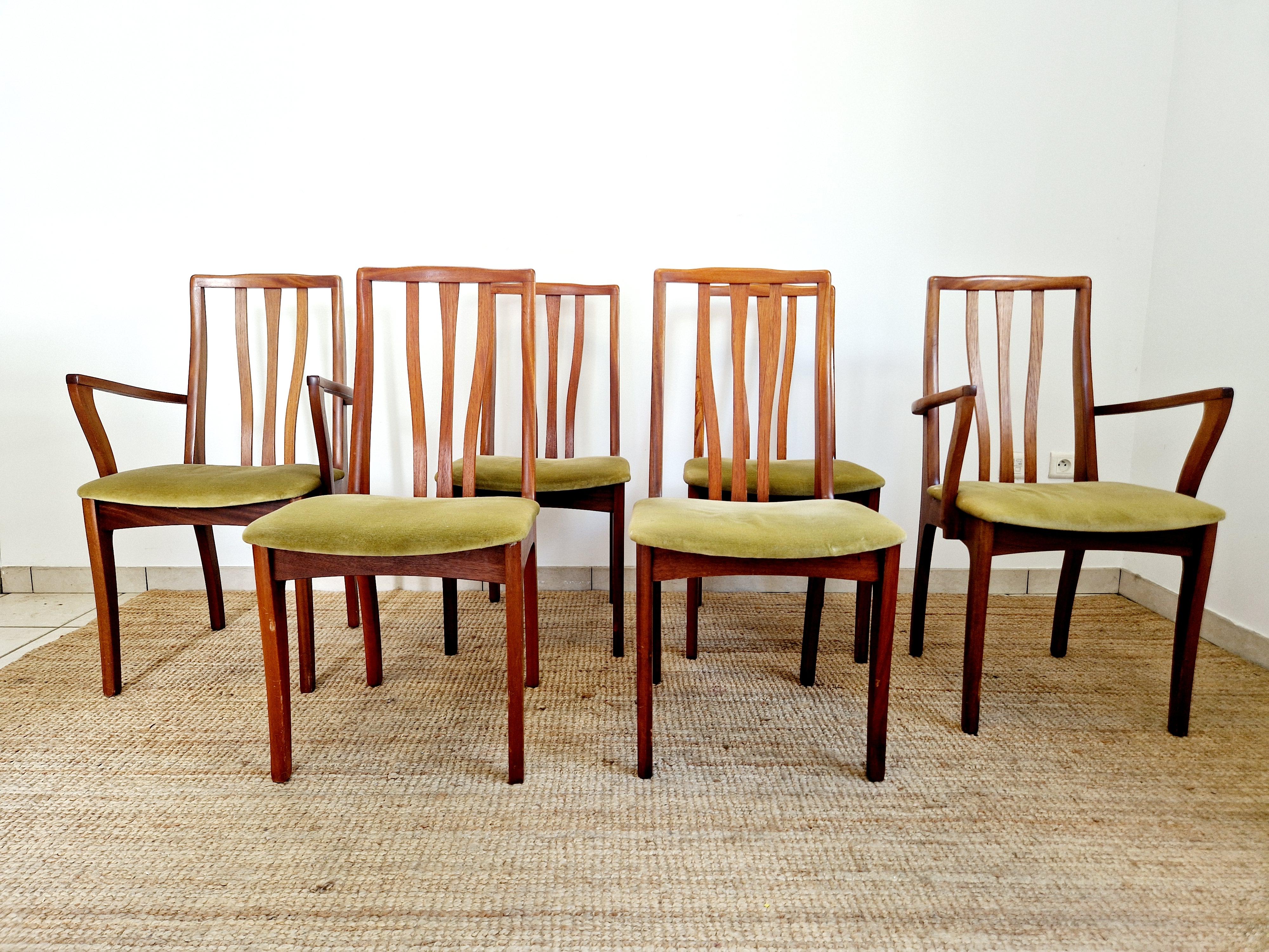 This Mid Century S Form Dining Table and 6 dining Chairs set is a great piece of vintage furniture from the 1960s. Made of teak with a brown finish, the oval shaped table has a length of 168cm. The chairs have a seat height of 46cm and are