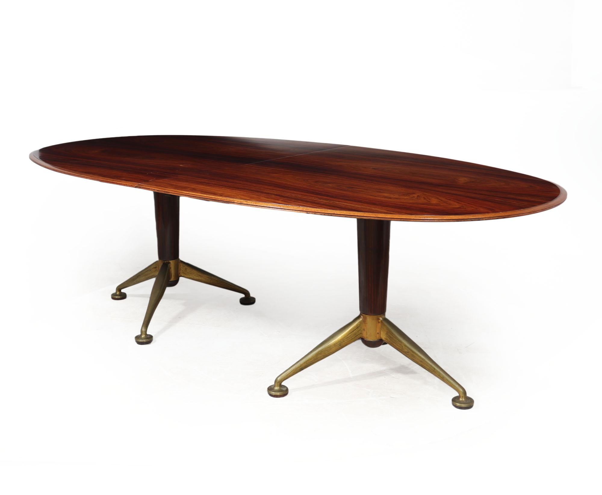  Dining table - Andrew Milne

An original 1950s Andrew J Milne dining table for Heals London featuring an elegant oval design crafted using rich santos rosewood. The table stands on set of distinctive brass splayed feet, anchored on a twin pedestal