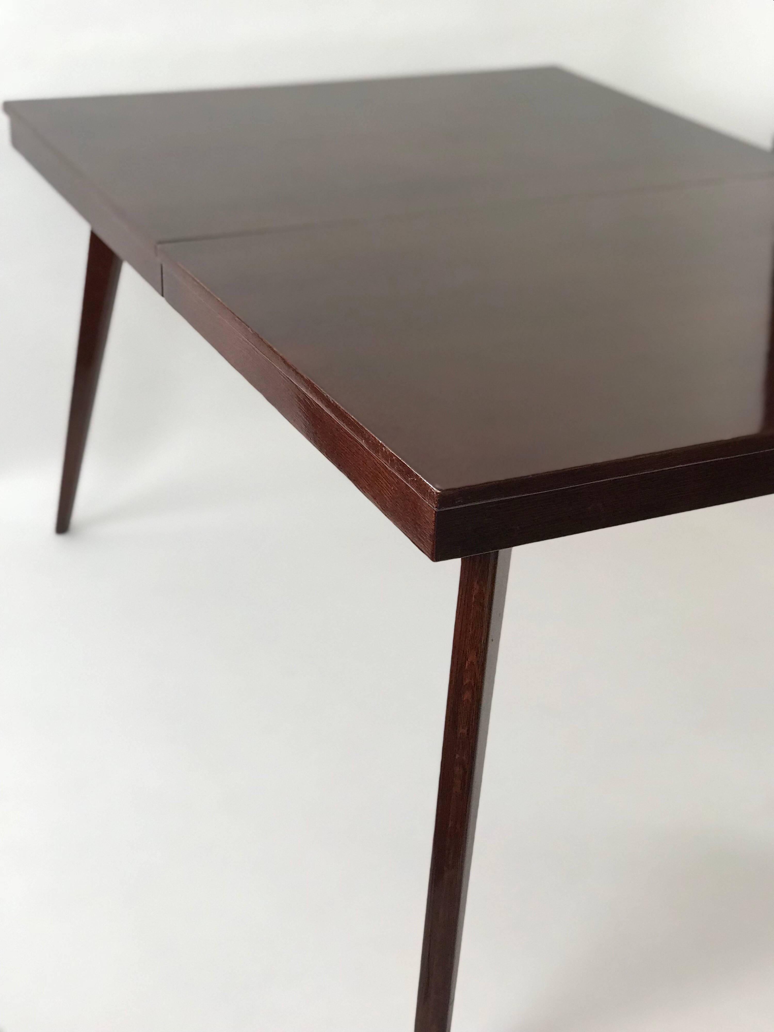 This is a beautiful Classic midcentury dining table in a polished mahogany by Gilbert Rohde for Herman Miller. Includes a black polished insert. Some scratches and one corner is dented. 

Dimensions with leaf: 72
