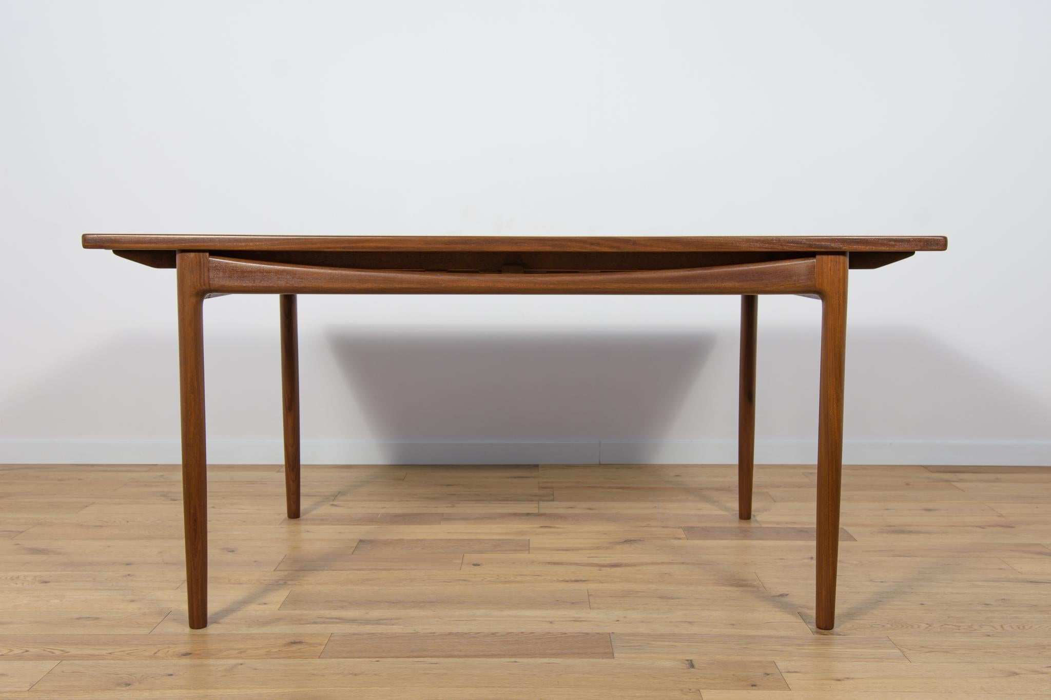 
This magnificent mid-century dining table was designed by Ib Kofod-Larsen and manufactured by G-Plan circa 1960. It is made teak. The table has border and fram made of solid teak. The table has profiled bottom strips, giving it a unique character.