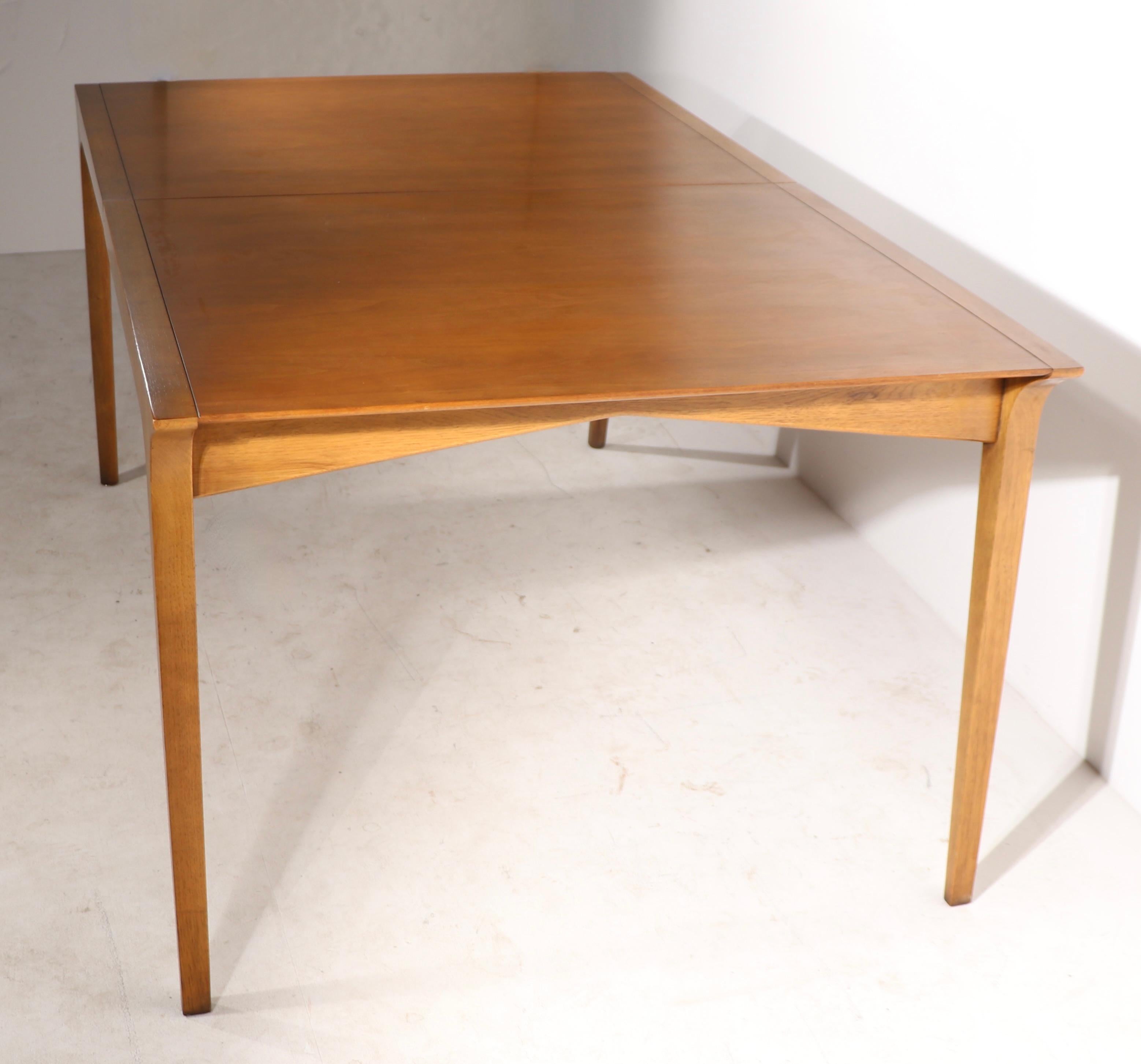 Sculptural and sophisticated architectural dining table, designed by John Van Koert for Drexel as part of the classic Profile series. This example is in very fine, original, clean condition. The table comes complete with three 12 in. leaves,