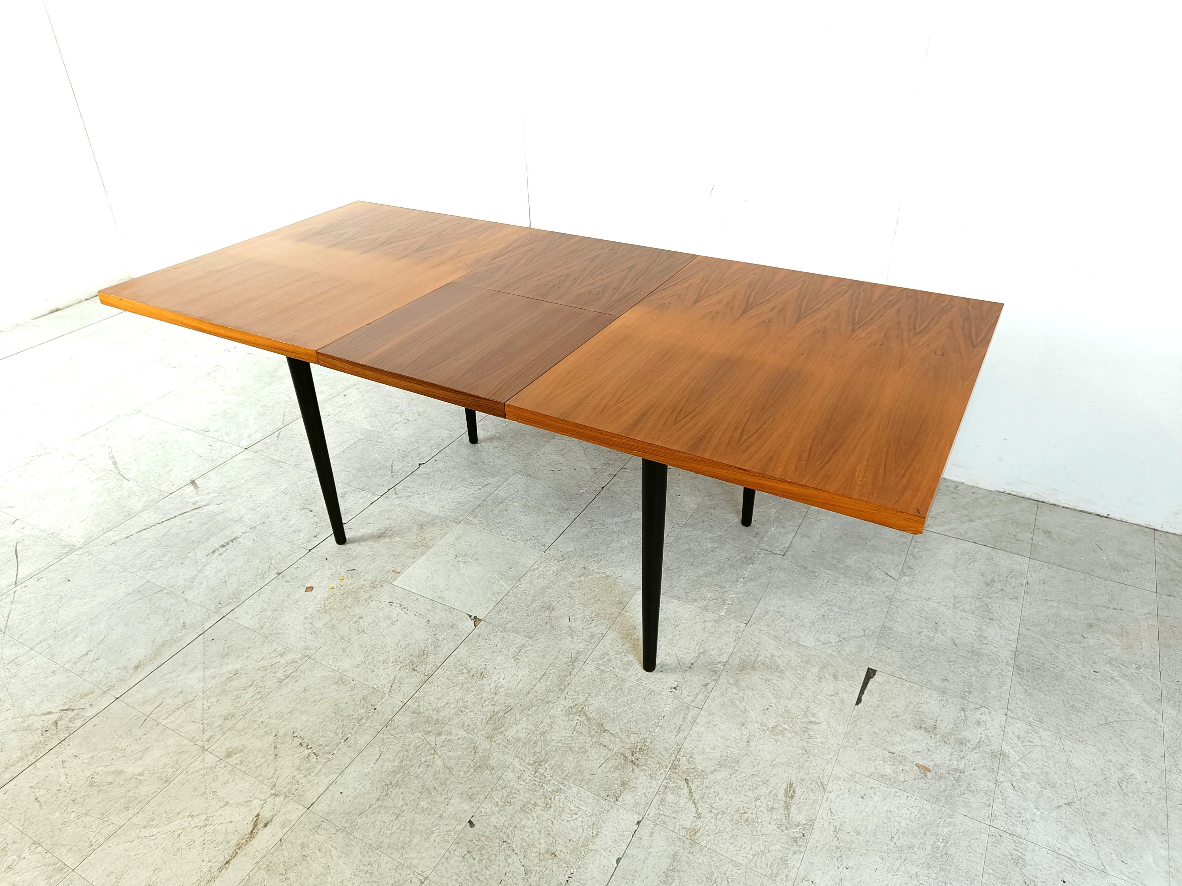 Mid century extendable dining tabled esigned by Belgian Designer Jos De Mey.

It has two extra table tops that fold out when you open up the table.

Beautiful wooden top with black ebonized legs.

Good condition with normal age related wear

1960s -