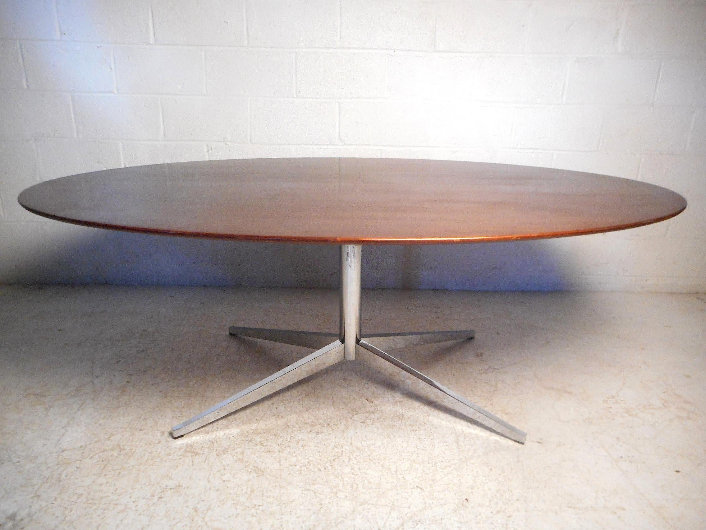 Impressive midcentury dining table by Knoll International. Large wooden tabletop supported by a sturdy chrome base. An impressive addition to any modern interior. Please confirm item location with dealer (NJ or NY).