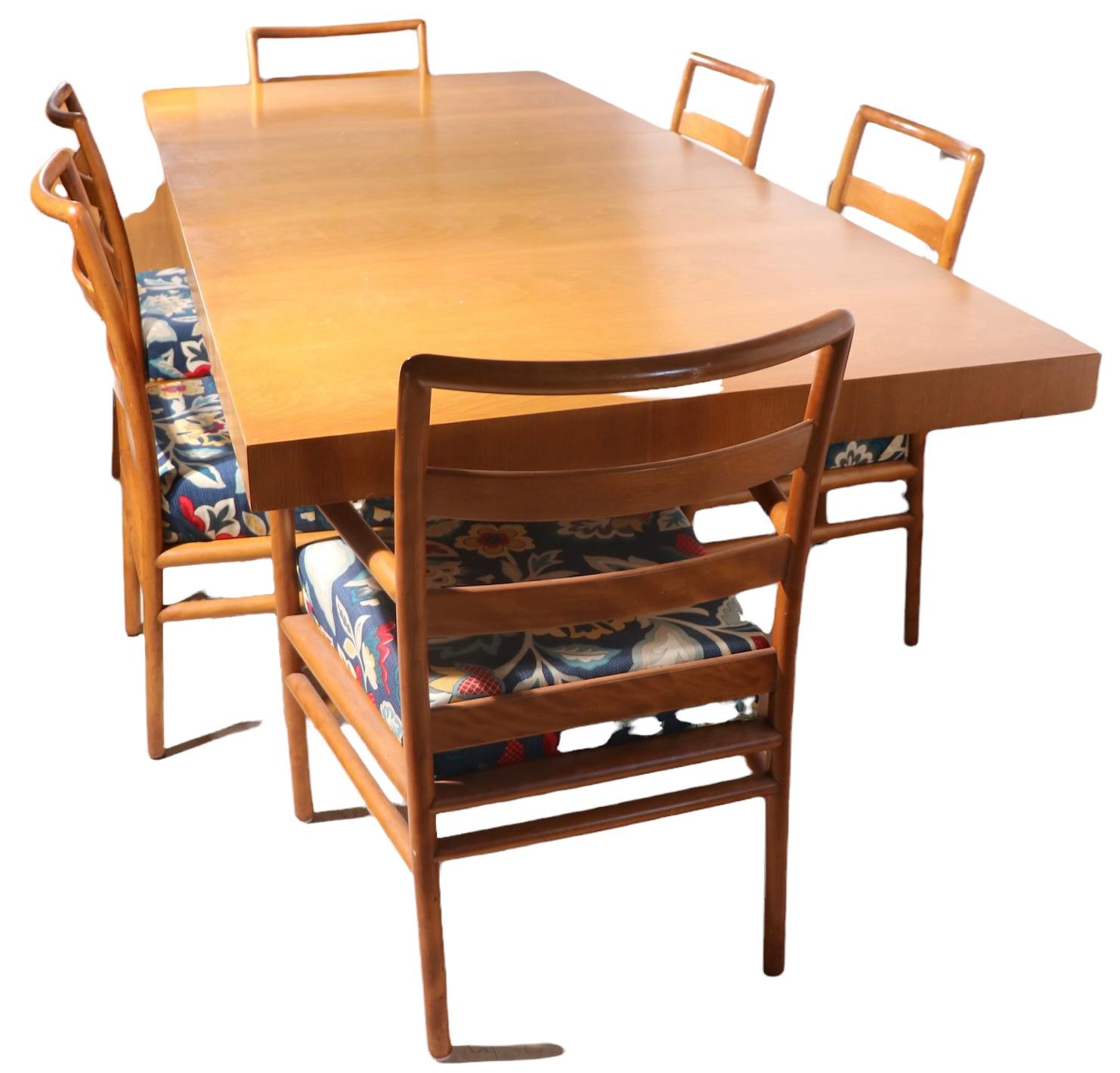 Iconic Mid Century dining table designed by Robsjohn Gibbings for Widdicomb. This example is in very good, original condition, showing only light wear consistent with age. Specifically, an inconsequential veneer flaw at the corner, and light