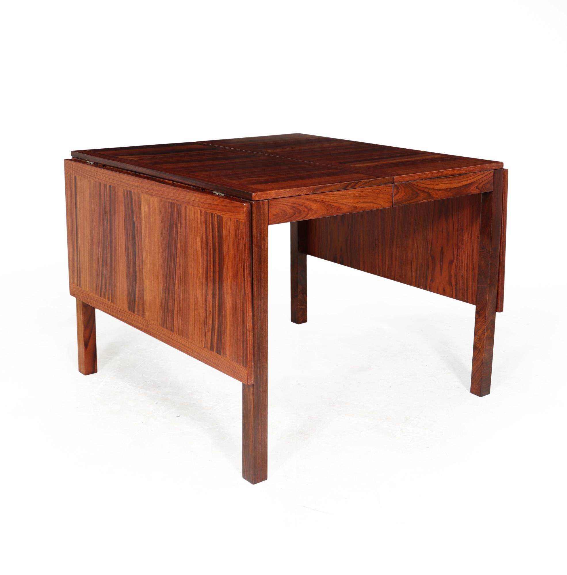 MID CENTURY DINING TABLE
A mid century drop leaf dining table deigned by Vejle Stole in Denmark in the 1970’s produced in Santos rosewood this is a rare example of this table, can seat up to 12 people when fully extended, the runners all run