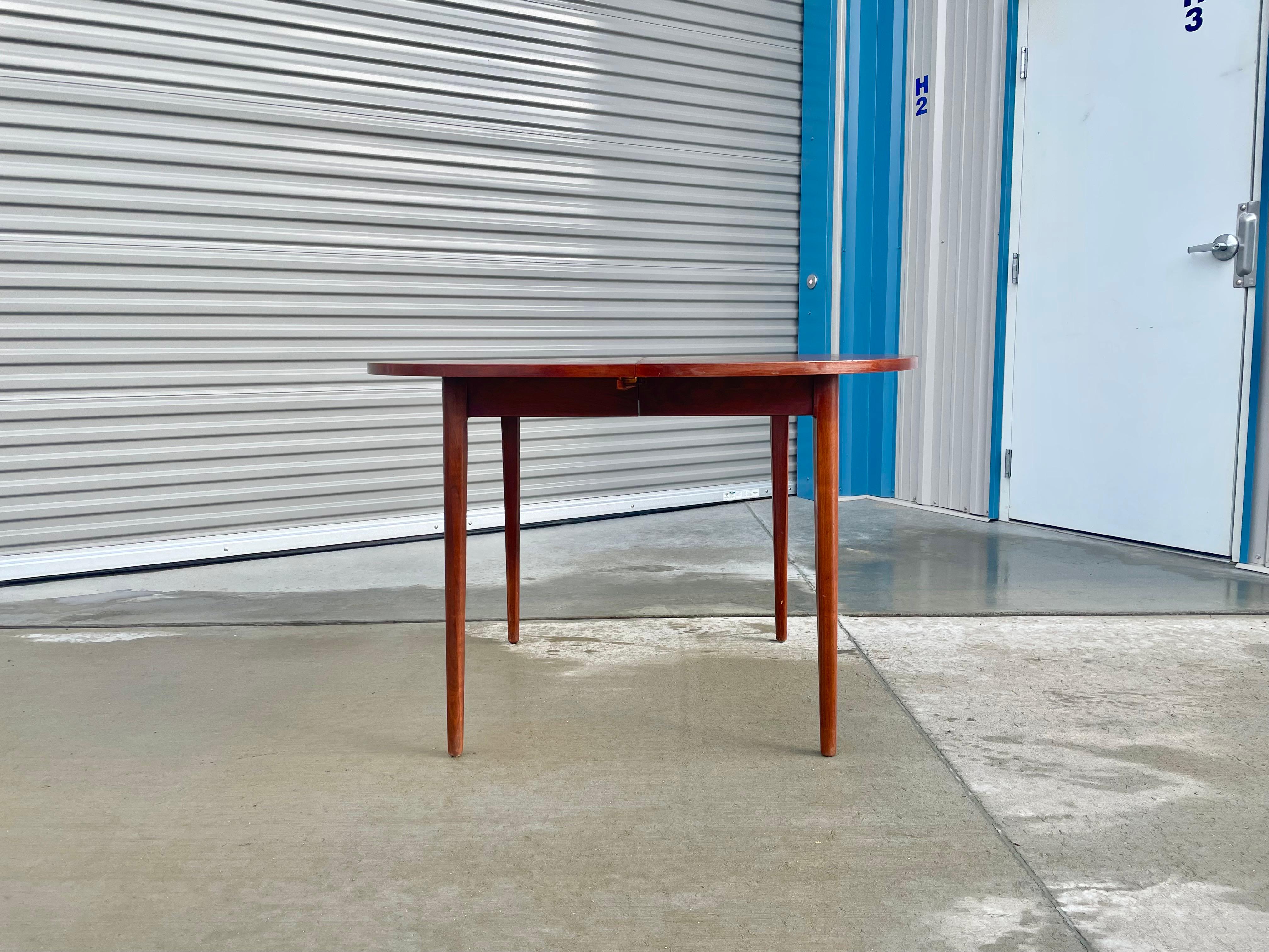 Midcentury dining table designed by Kipp Stewart for Drexel, circa 1950s. This stunning dining table features a strong solid walnut frame that gives an excellent color tone and a beautiful grain pattern creating a refined and elegant look. The