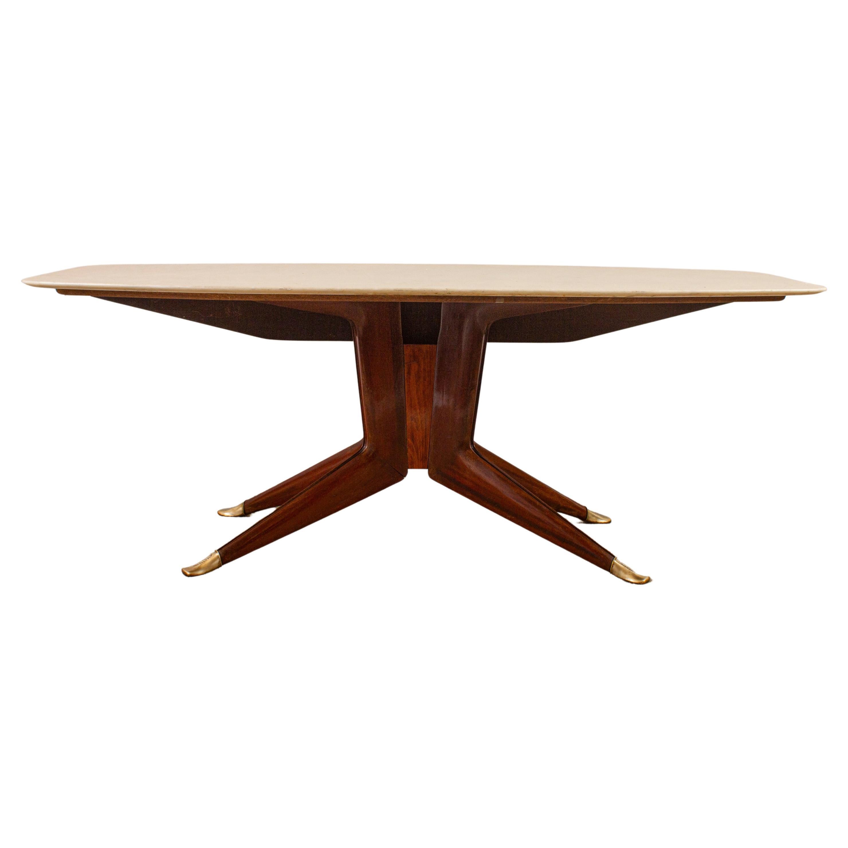 Striking  Mid-Century table with octagonal shape  white Carrara marble top.
Features an elegant  sculpted modular support structure made by walnut .
 From the central join  the legs extend downwards toward the floor , finished with bronze tips.
This