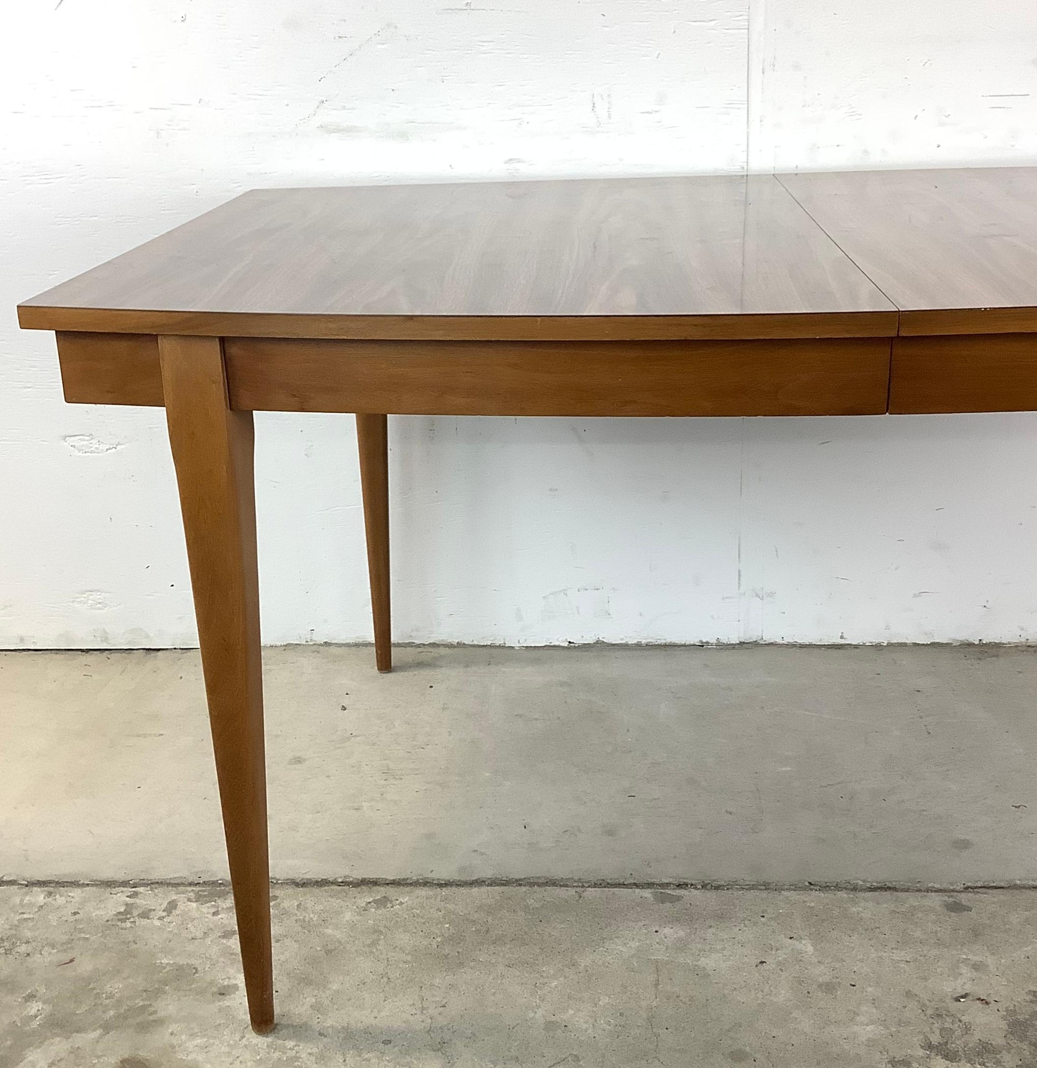 This Mid-Century Dining Table with Removable Table Leaf makes the perfect centerpiece for entertaining in style. This is your chance to add a bit of the sleek mid-century modern style that defined 20th century American design- this dining table is