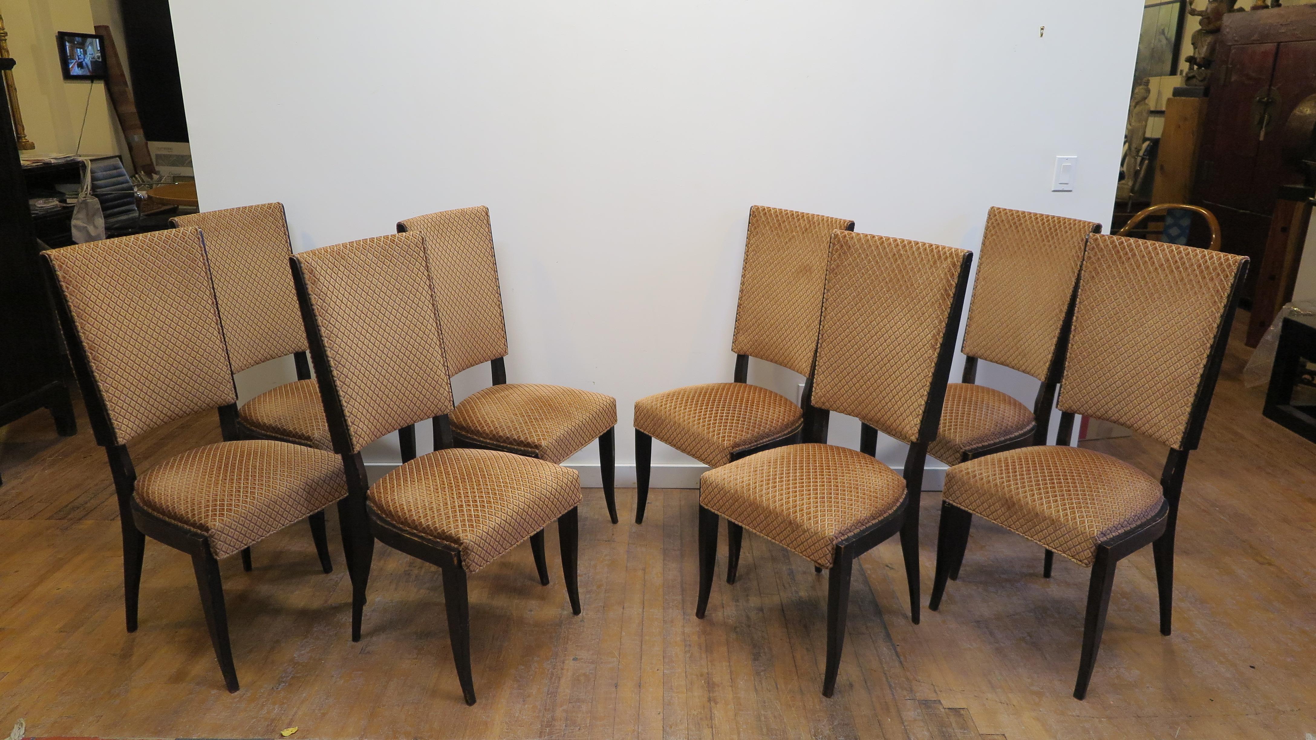 French midcentury dinning chairs in the style of Jules Leleu. Set of eight midcentury French dinning chairs. High back dinning chairs. This set of eight chairs are in original condition with period fabric. The set can be used as they are but