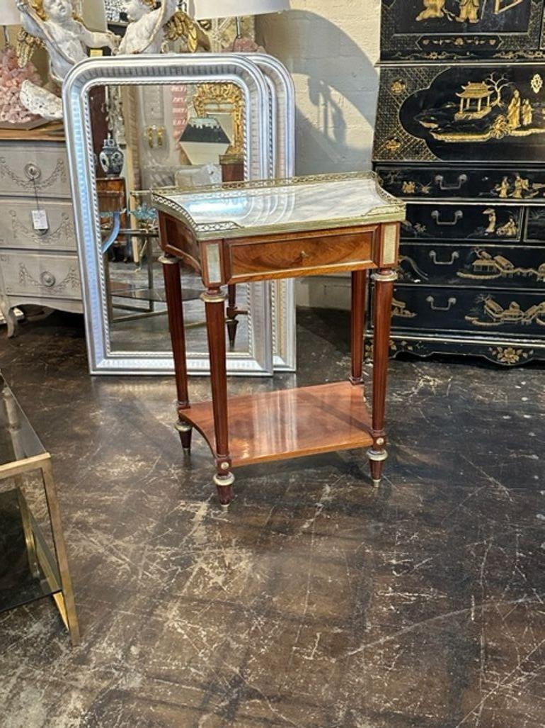 Elegant mid-century Directoire' style mahogany and brass console with a marble top. Attributed to Jansen. Adds a real touch of class to your decor. Lovely!