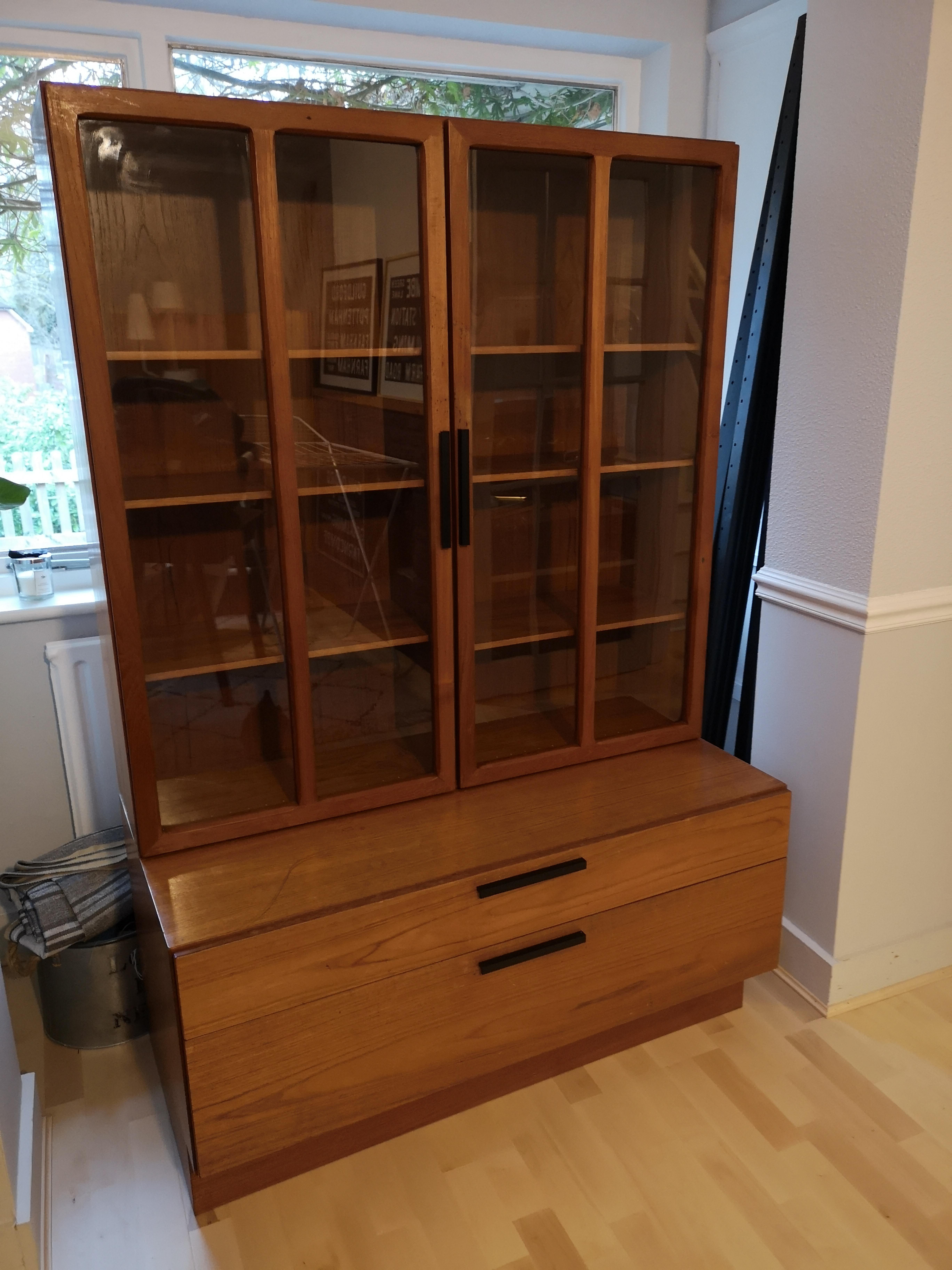 A stunning midcentury Display Cabinet by Ib Kofod Larsen for Faarup Möbelfabriken. The cabinet consists of low sideboad with drawers and a display cabinet with glass doors on top.