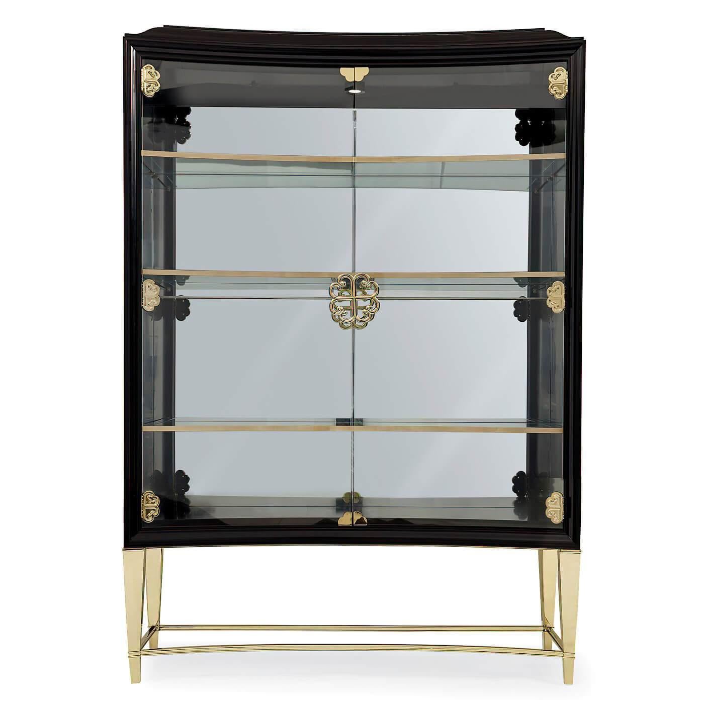 A mid century style satin ebonized two-door display cabinet with a dramatically shaped front and full-length glass doors. A clear mirror back reflects your collection of beautiful pieces and crisp spotlights add the sparkle.

The glass doors