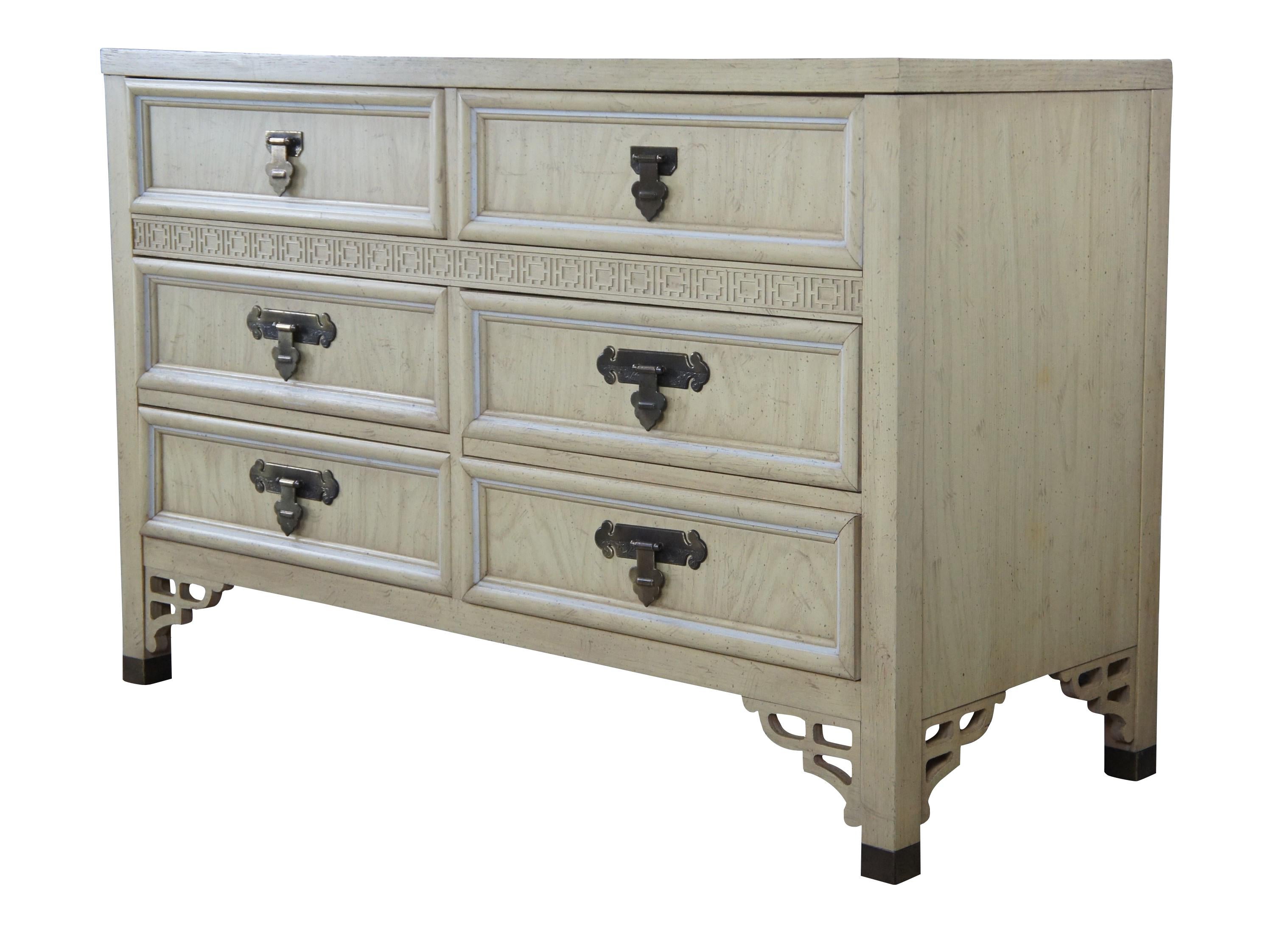 Mid-20th century pickled oak Campaign chest of drawers by Dixie. Part of their Shangri La chinoiserie collection. Features six dovetailed drawers, fretwork and brass hardware. Naturally distressed. Marked double dresser 322-506 along the back.