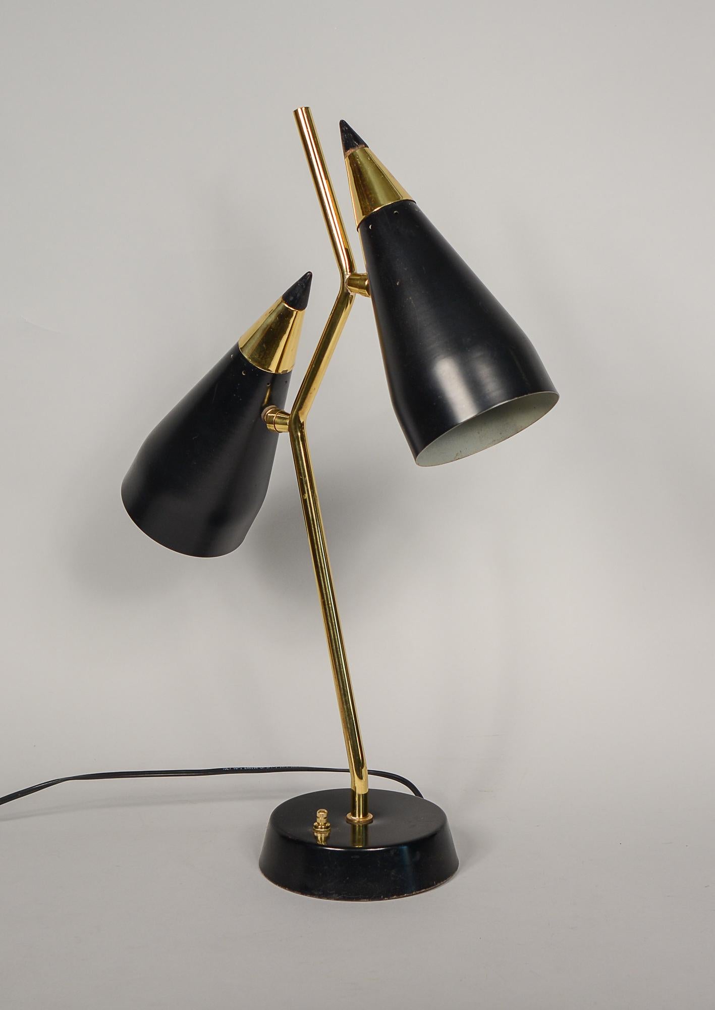 Sculptural double cone desk or table lamp. This lamp has a three way enabling the user to light either shade at a time or both at the same time. The lamp has the original finish there are a few scratches to the shades and wear to the base. The lamp