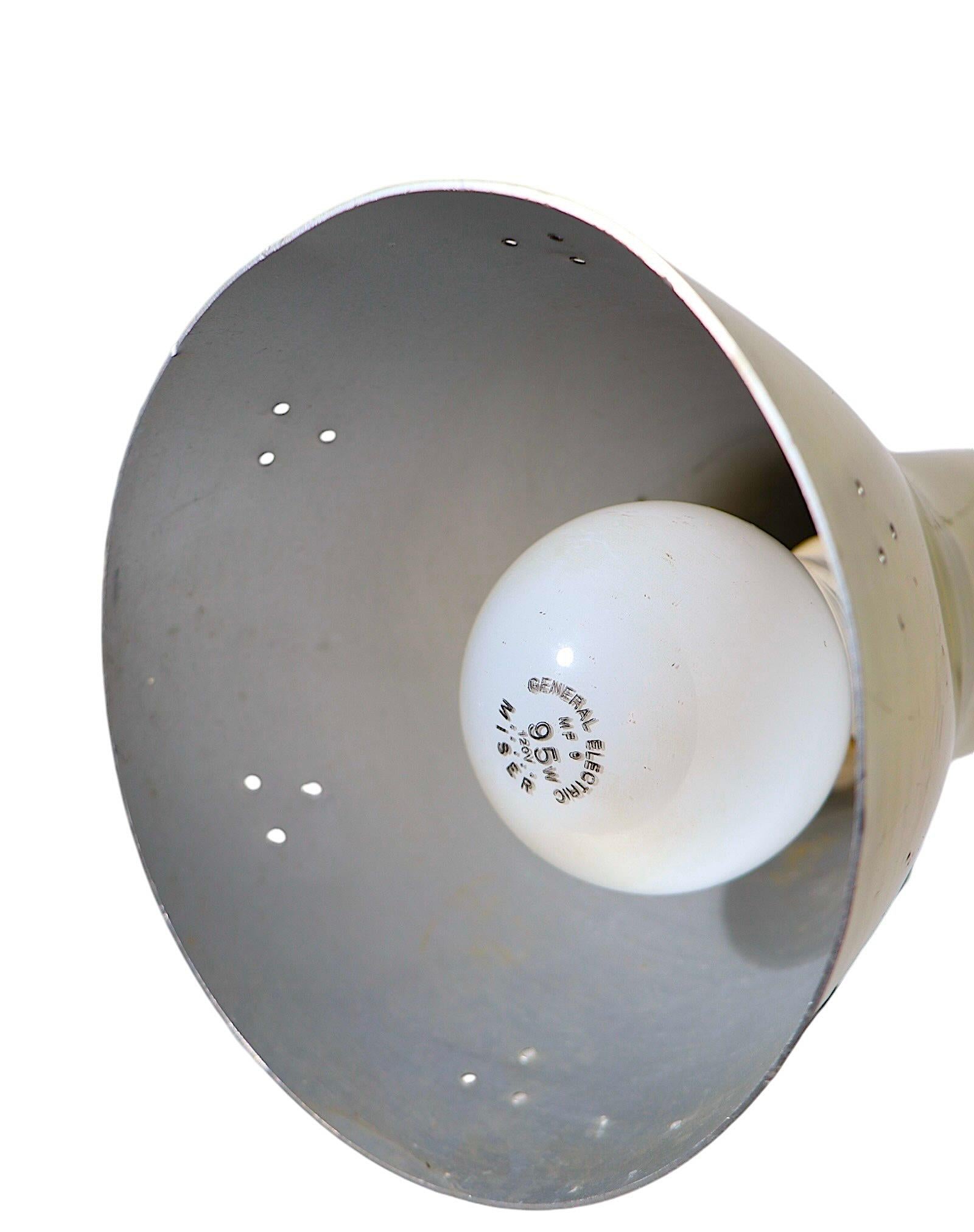 Classic Mid century Modern gooseneck desk, table lamp, having two flex arms,  and metal cone form hood shades.  This example has a three way on/off switch allowing either socket to be lit , or both  to be lit simultaneously. The lamp is in good,