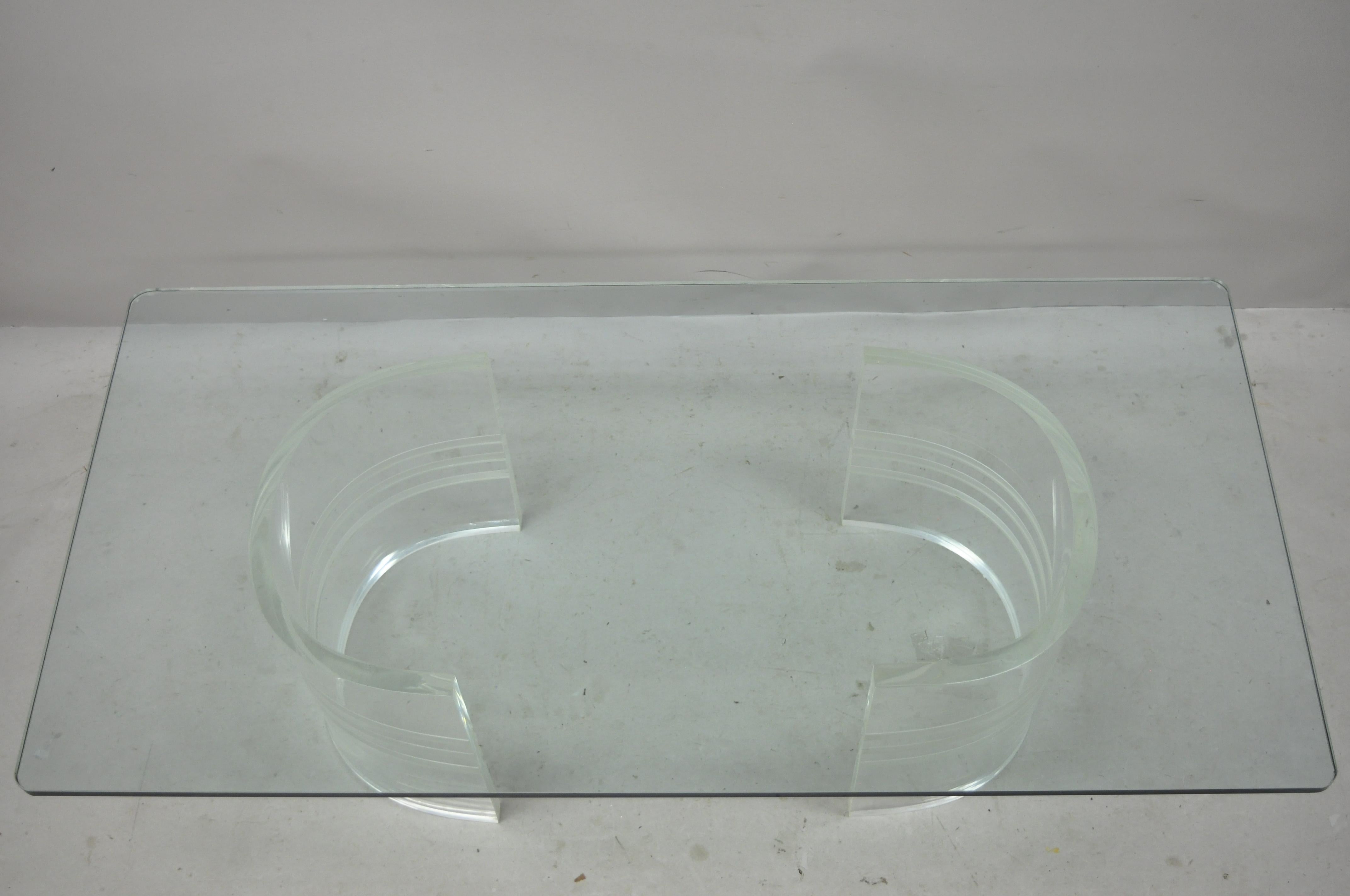 Mid-Century Modern double pedestal curved Lucite base rectangular glass top sculptural coffee table. Item features .75