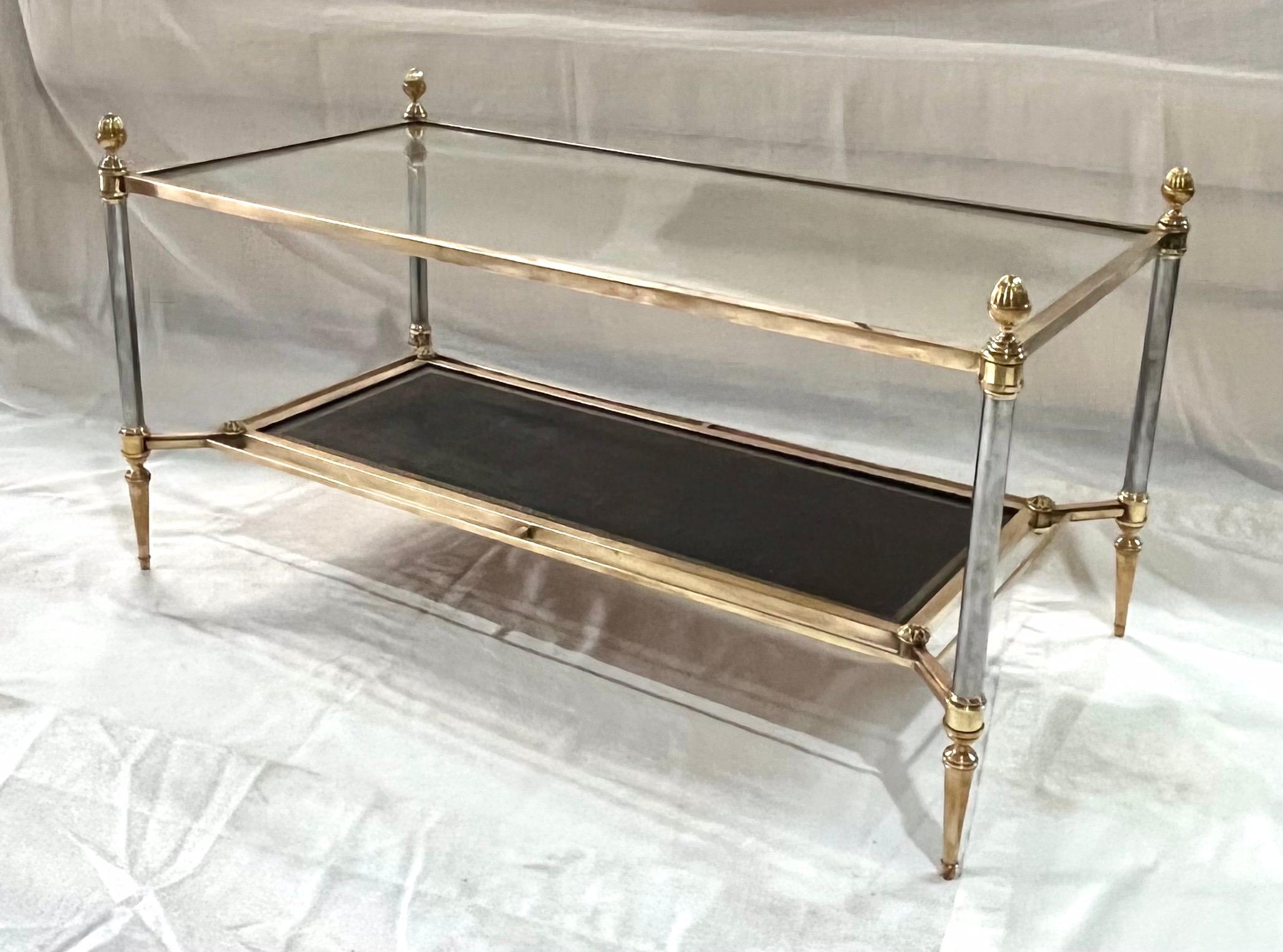 Double tray Mid-Century coffee table by Maison Jansen.
Neoclassical style 
Bronze frame and crystal glass top.
 The lower level in black leather.
 