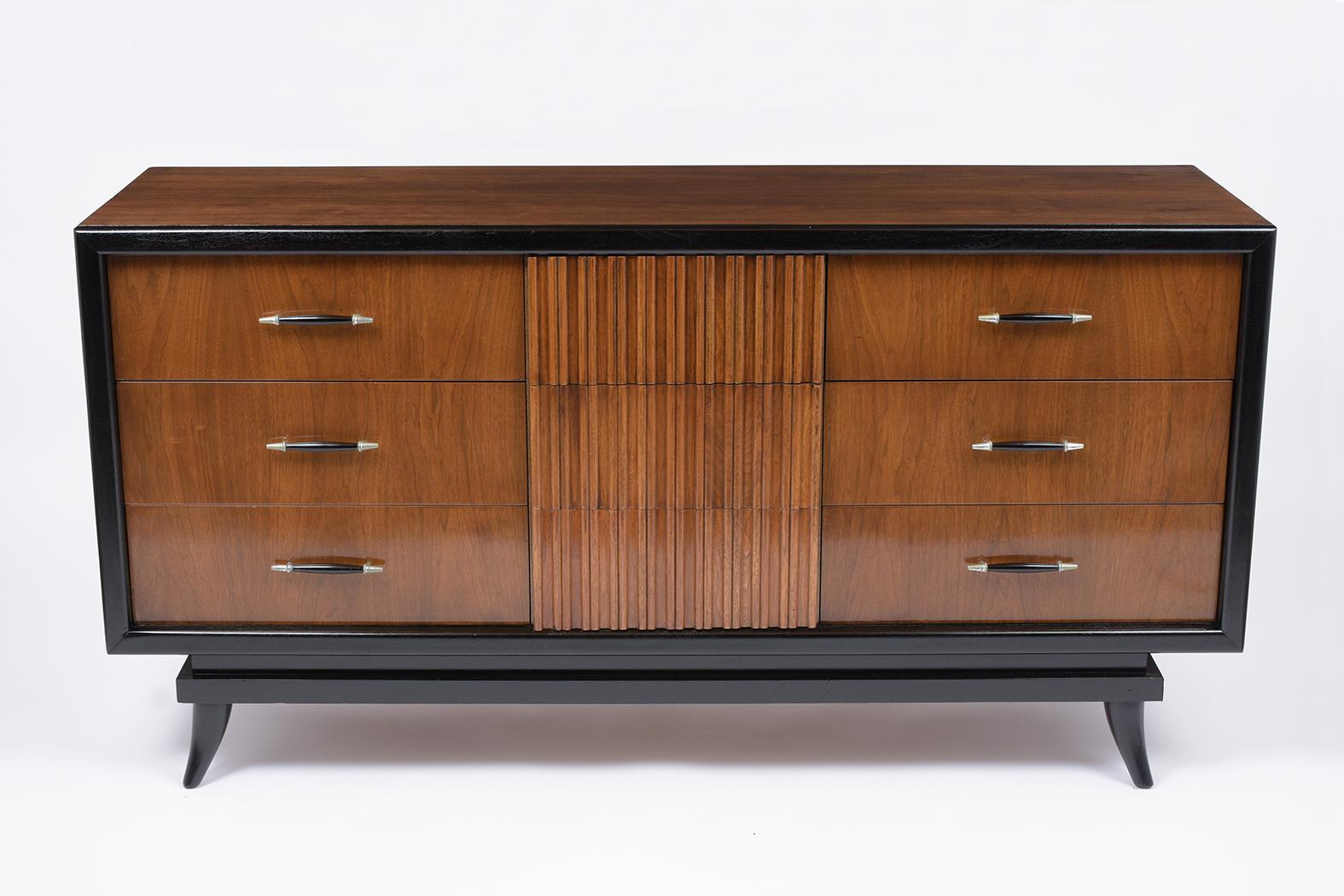 This modern chest of drawers has been fully restored and is made out of walnut wood, and is newly stained in walnut and black color combination with a lacquered finish. This dresser features nine drawers, six of which come with carved wood handle