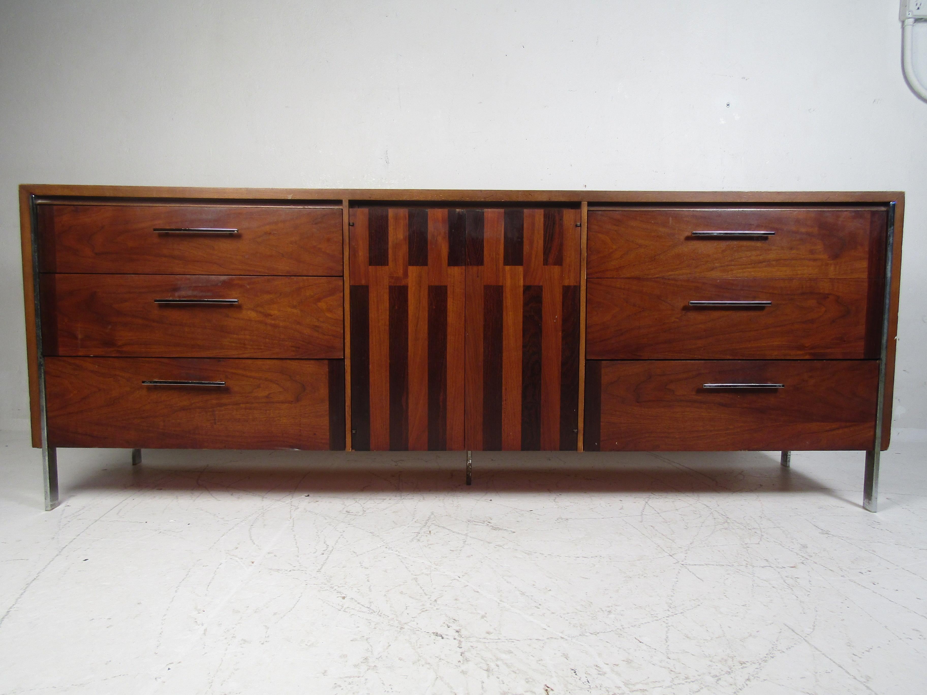 Mid-Century Modern dresser manufactured by Lane. Interesting design with inlays scattered across the drawer-fronts. Chrome drawer pulls and legs. Please confirm item location with dealer (NJ or NY).