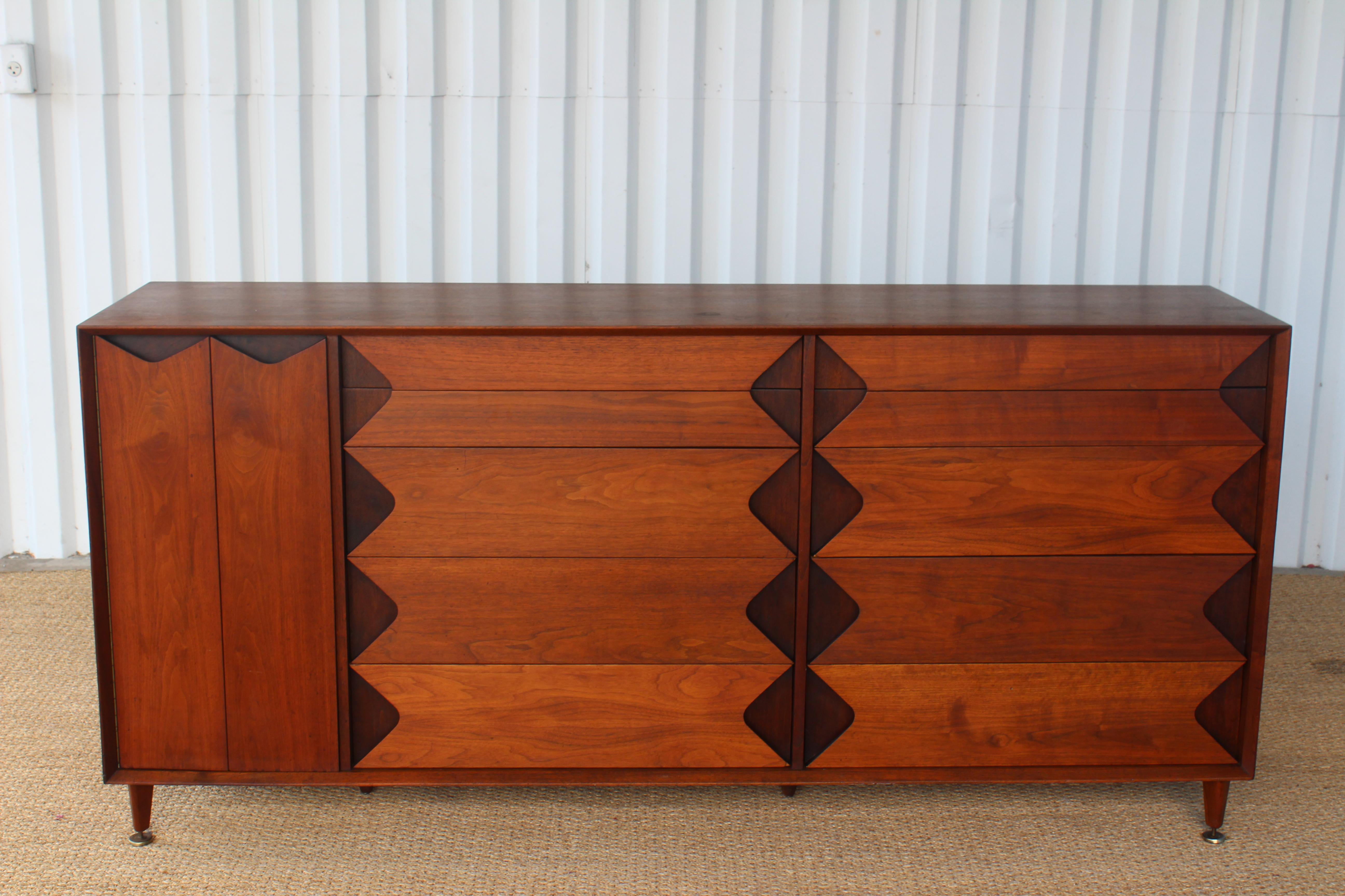 Vintage mid century walnut dresser, designed by Marc Berge for Grosfeld House. Features ten drawers and a bi-fold compartment with two interior adjustable shelves. In good condition with some minor signs of wear. Original oiled walnut finish.