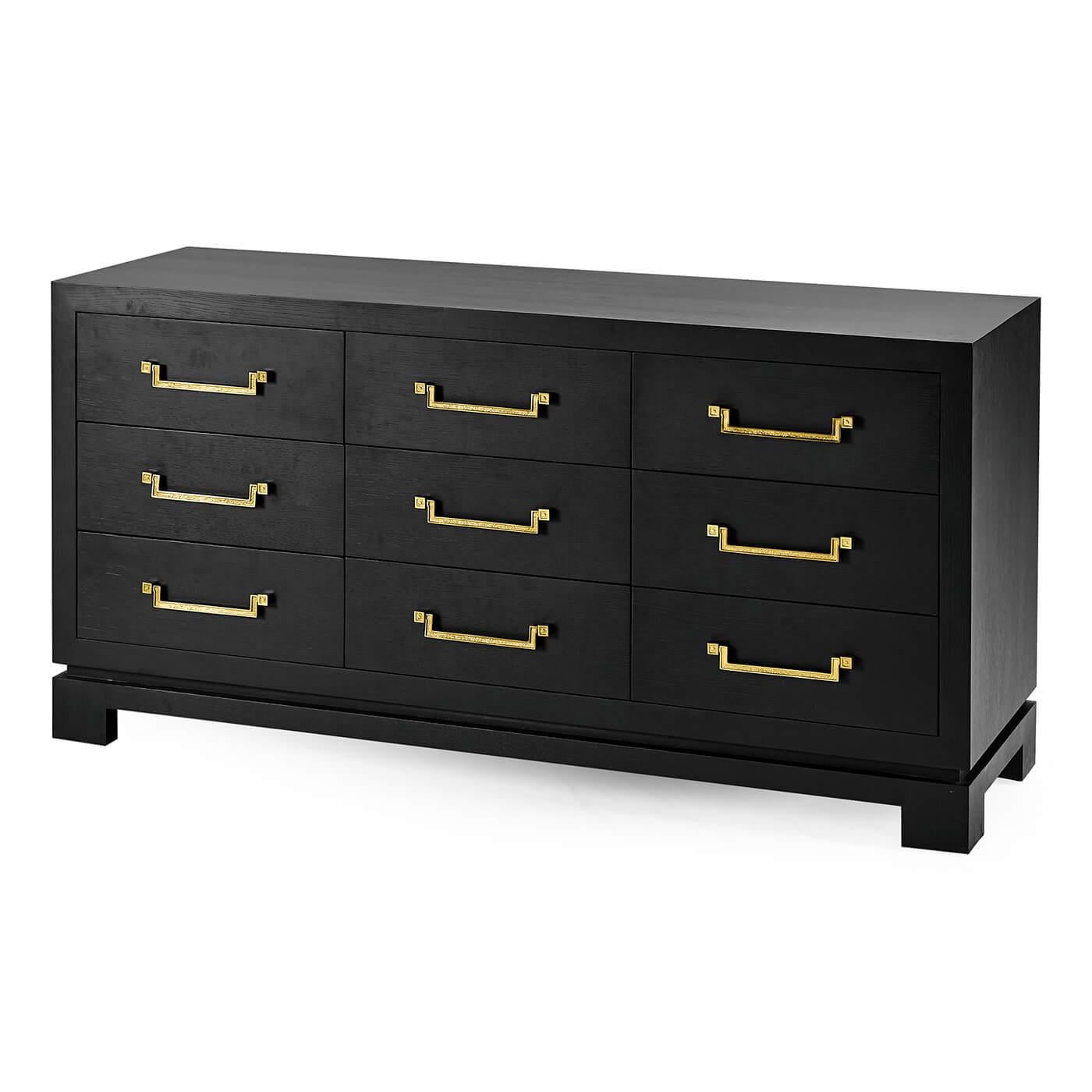 A Mid-Century Modern ebonized oak nine drawer dresser. Exquisite Chinese influence on the custom brass handles and base with three columns of drawers - this dresser has antique design and mid-century influences.

Dimensions: 65