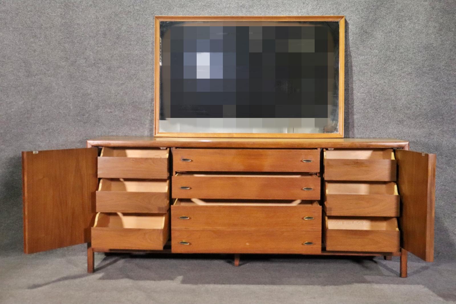 Long walnut dresser with total drawers, six hidden by doors with inlay grain. Includes a large wall mirror.
Mirror: 32h, 49w
Please confirm location NY or NJ