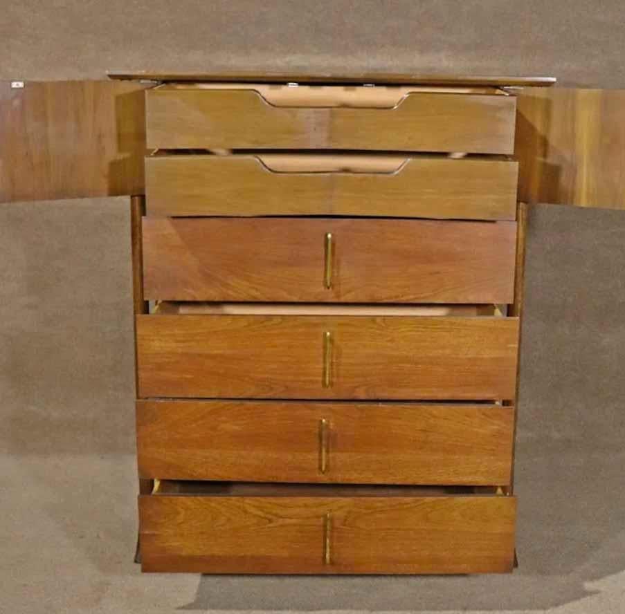 Tall chest of drawers with a unique mid-century design. Six total drawers with brass hardware set inside sculpted wood frames.
Please confirm location.