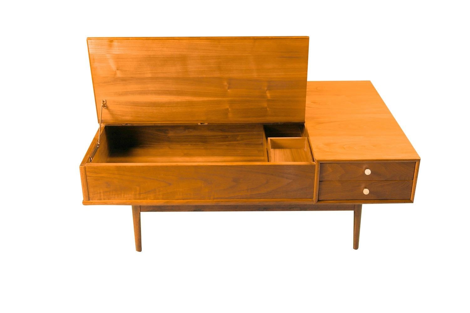 Fabulous Mid-Century Modern coffee table designed by Kipp Stewart and Stewart MacDougall for Drexel’s Declaration Collection, circa 1960s. Featuring a rectangular top in beautifully grained walnut wood above two drawers on the right, each drawer is