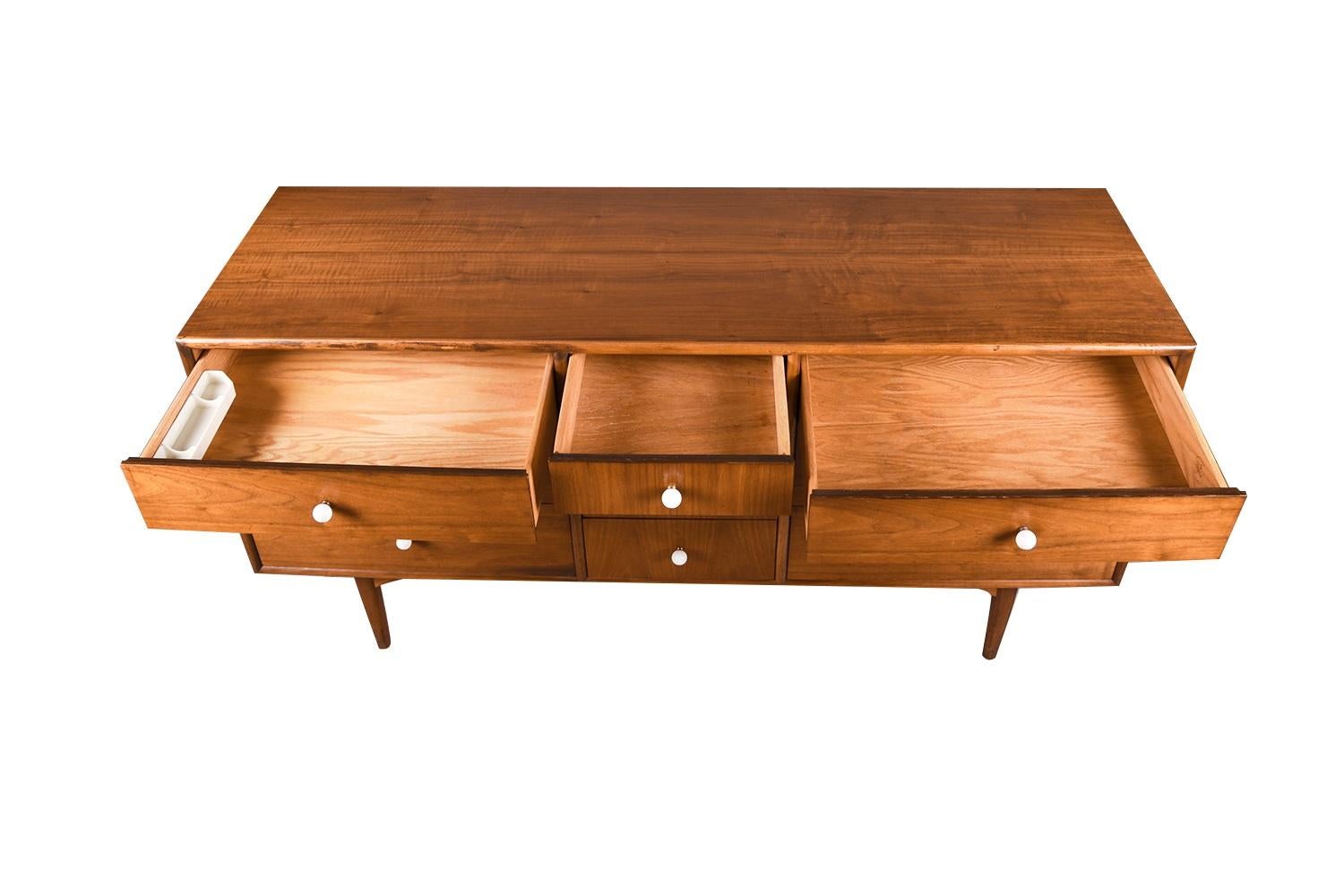 Fabulous Mid-Century Modern 10 drawer triple dresser or credenza designed by Kipp Stewart and Stewart MacDougall for Drexel’s Declaration Collection, circa 1960s. Featuring a solid, beautifully grained walnut wood case and rounded convex frame