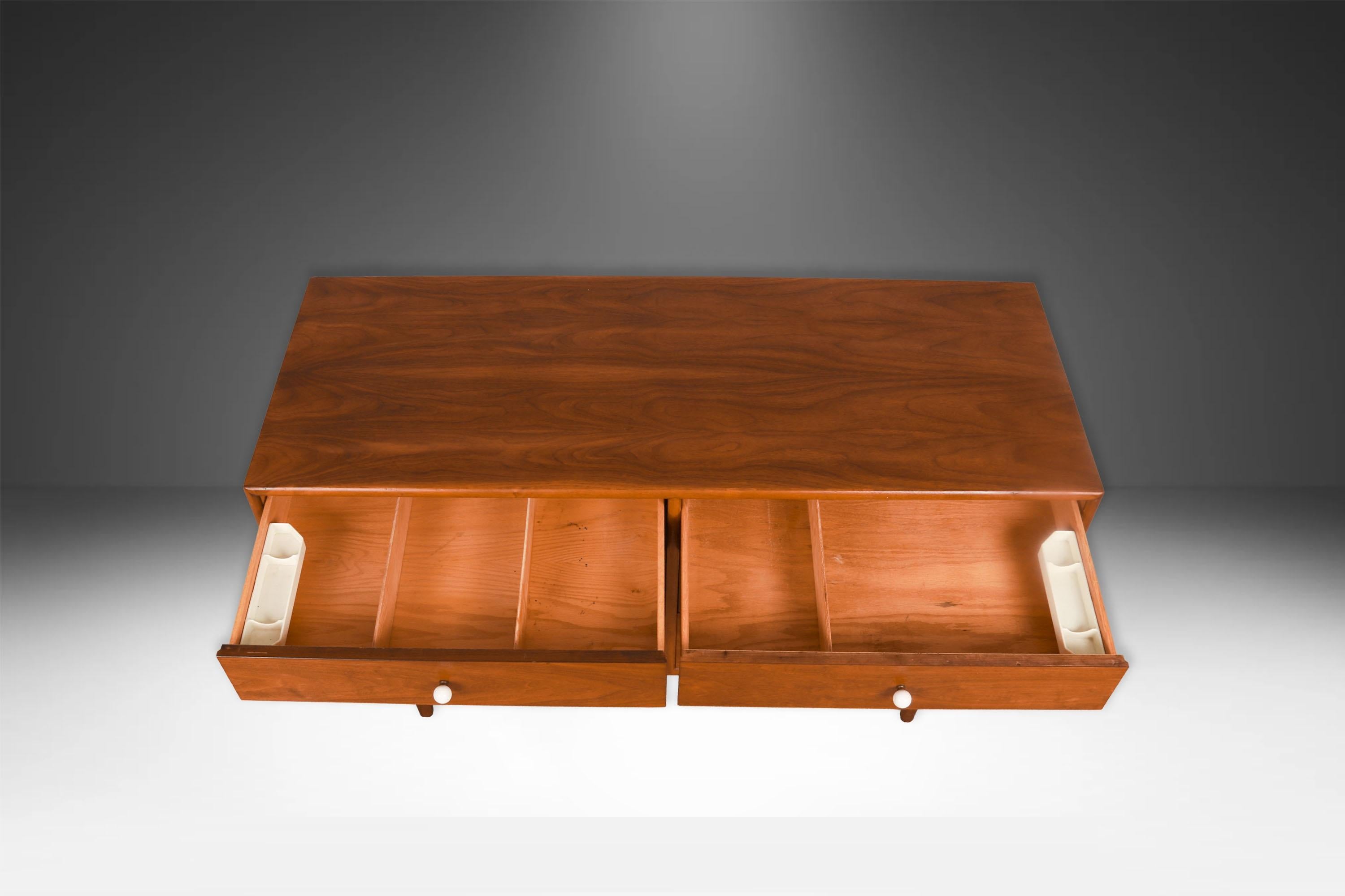 Beautiful Mid-Century Modern double dresser designed by Kipp Stewart and Stewart MacDougall for Drexel’s Declaration Collection, circa 1960’s. Featuring a solid, beautifully grained walnut wood case and frame, housing six drawers each is adorned