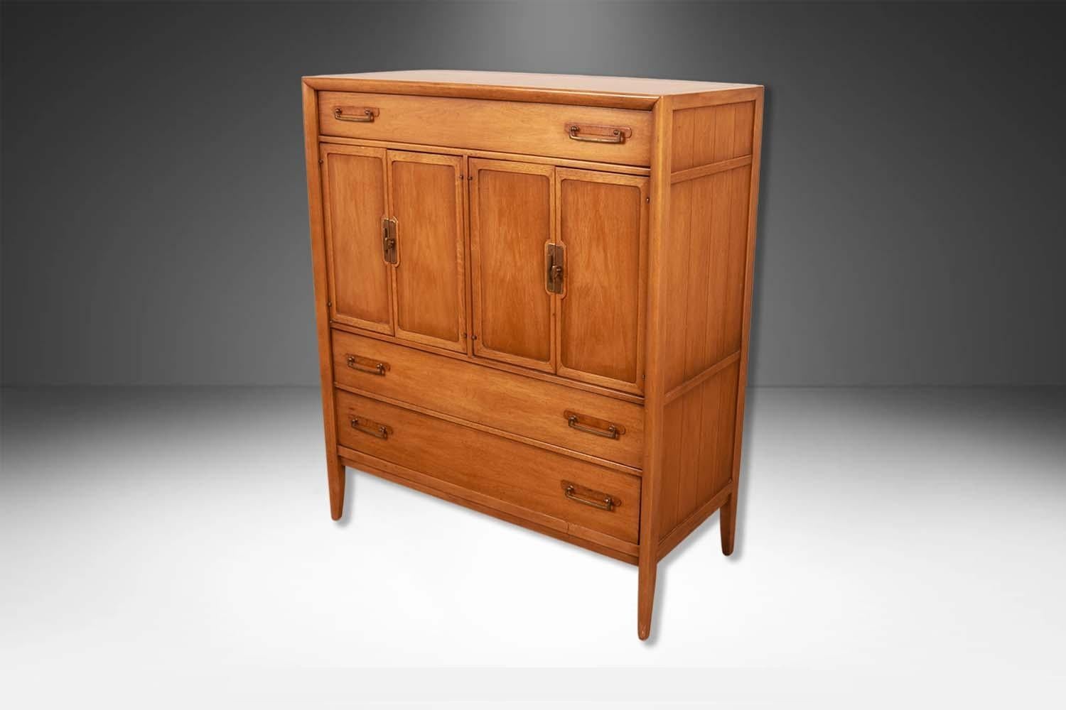 Stunning MidCentury dresser / gentleman's chest designed by James Bouffard for Drexel circa 1960's from the Meridian collection features a top drawer with divider. Makers Label on the inside of the top drawer (Drexel). Above a pair of center cabinet