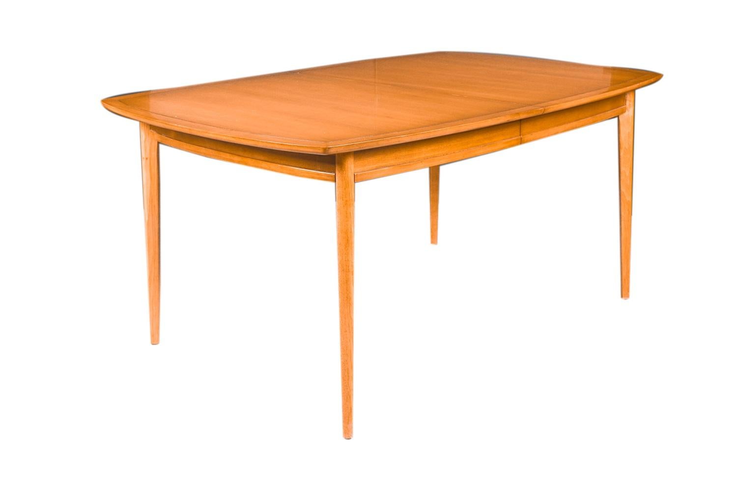 Beautiful Mid-Century Modern expandable Drexel Heritage Meridian dining table designed by James Bouffard for Drexel's Meridian collection circa 1960's. Features richly grained, butternut wood, clean lines characteristic of classic Danish design.