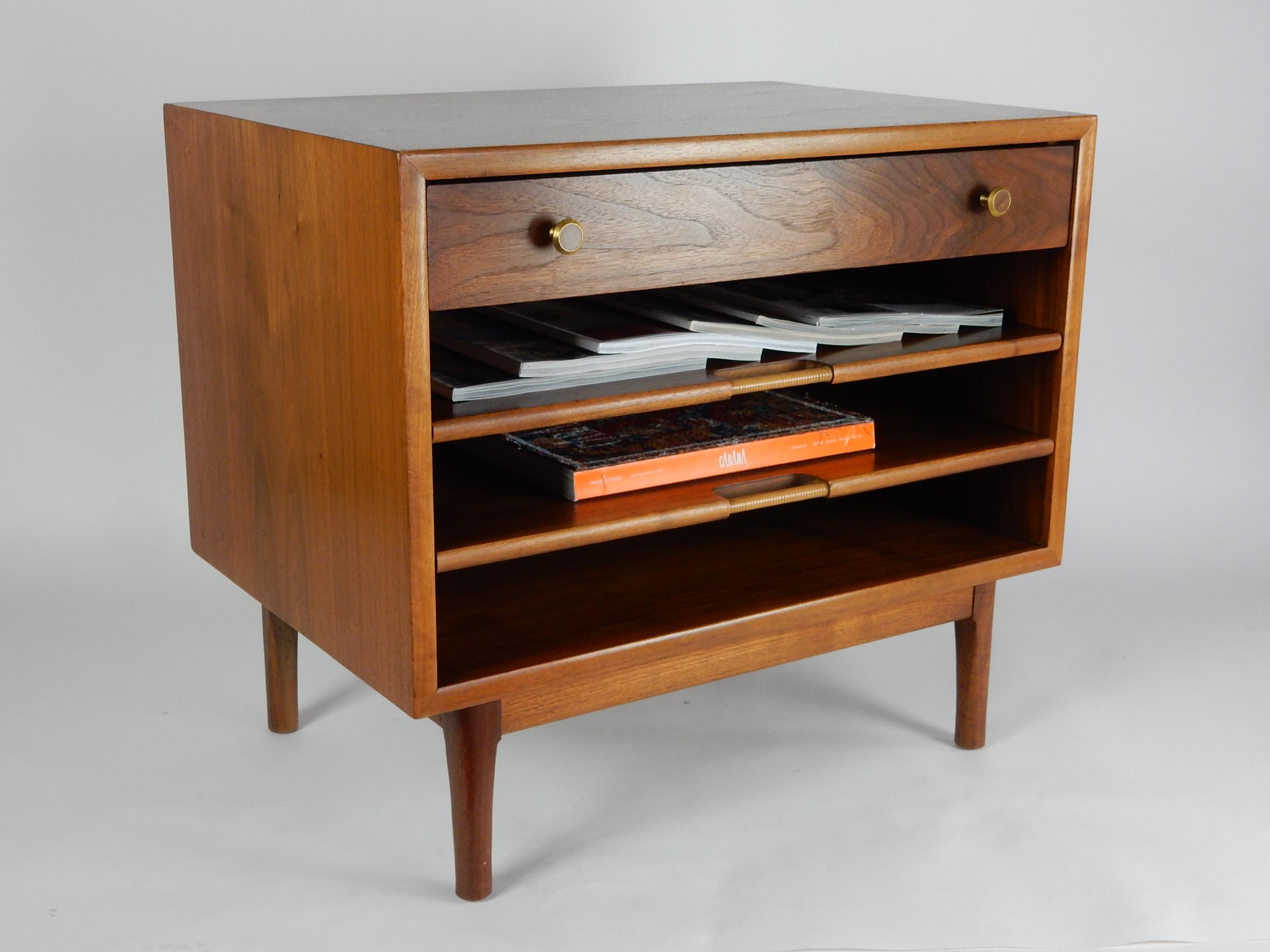 Exceptional walnut magazine table by Kipp Stewart and Stewart MacDougall for Drexel Declaration, circa 1960's.
Single top drawer and two pull out shelves with rattan-wrapped pulls
to display your favorite magazine selections.
Each shelf holds 8-10