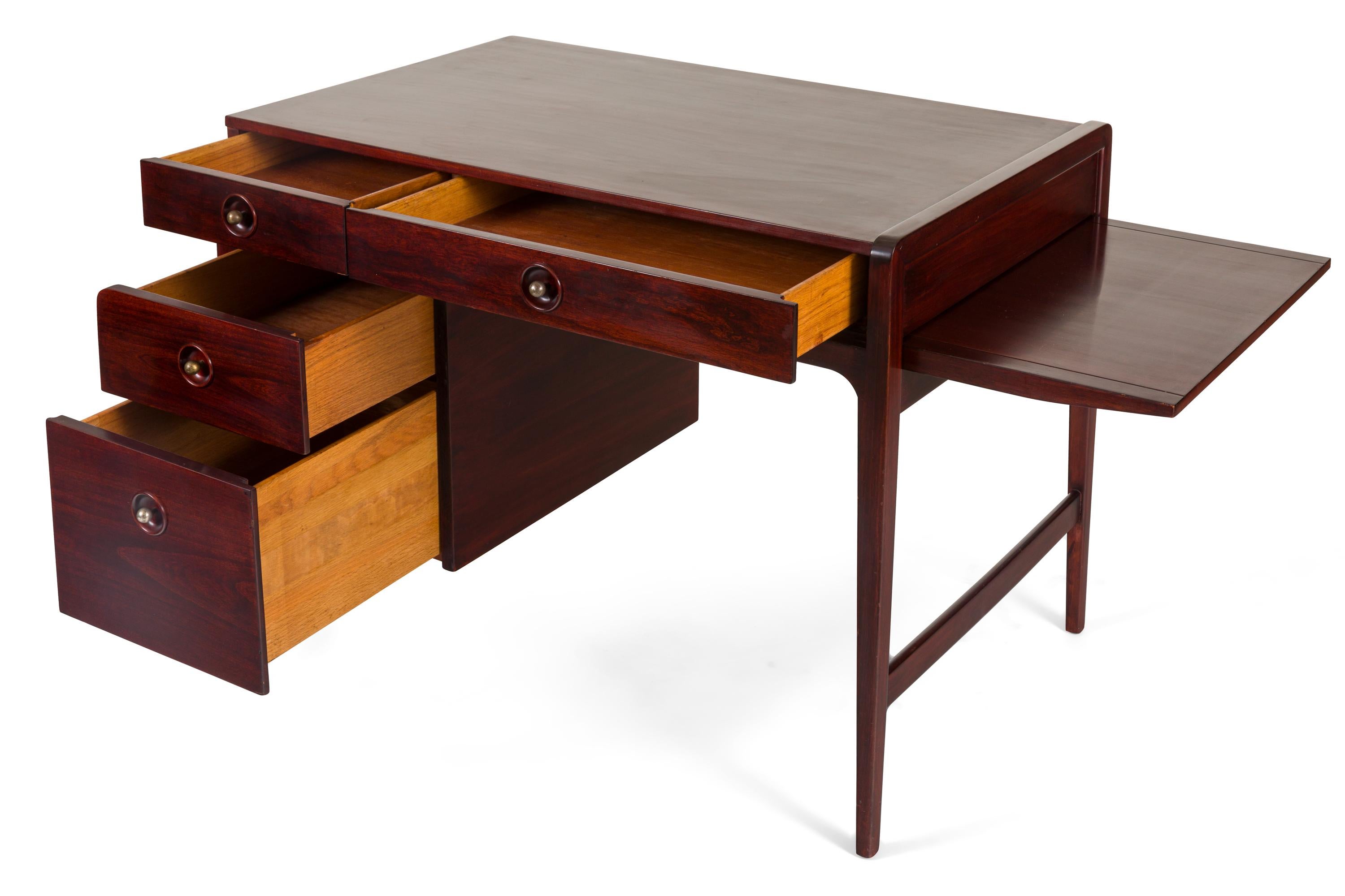 A classic early mid-century design. The small size along with the extending side surface makes this a practical as well as great looking desk.