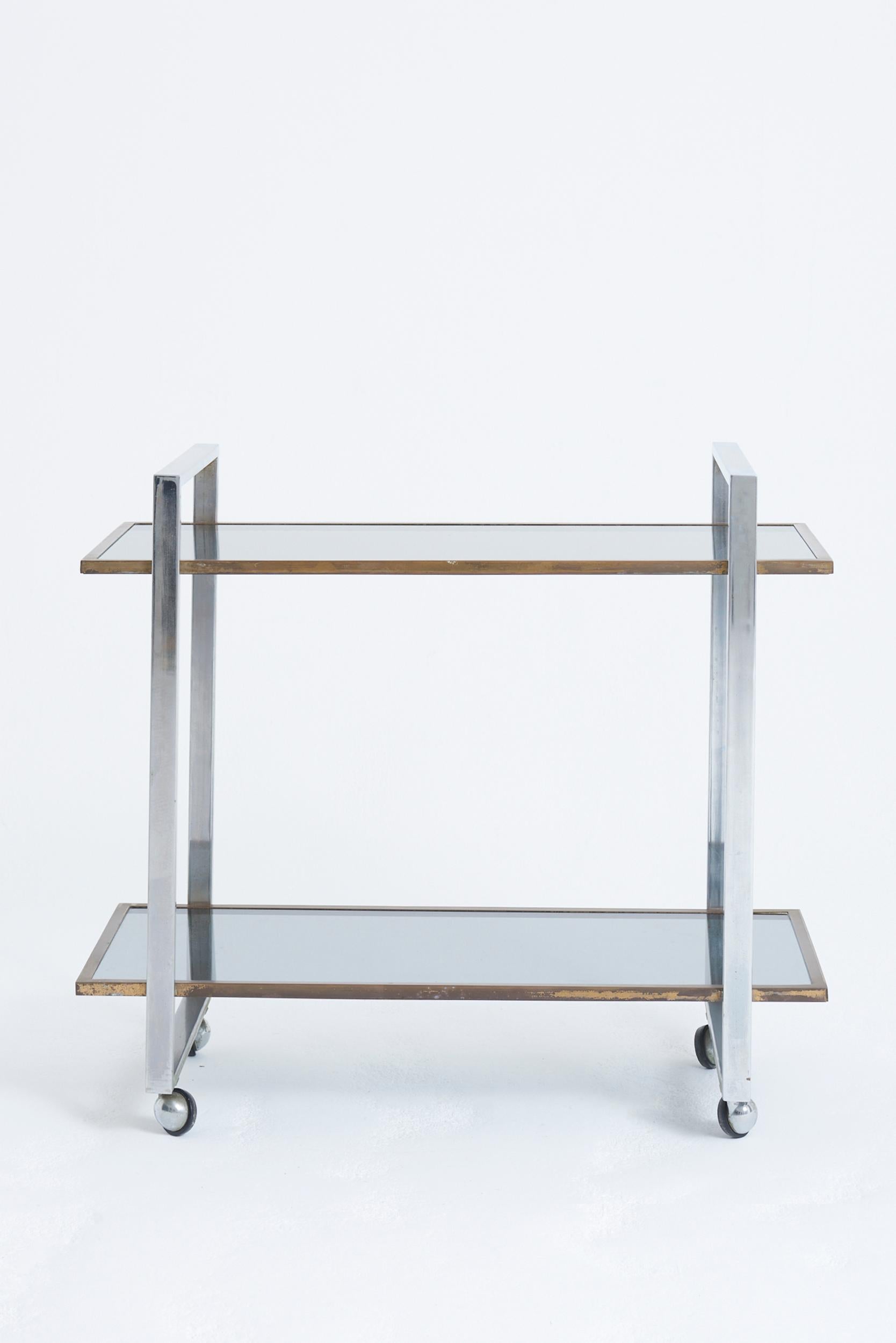 A brass, nickel and smoked glass two-tier drinks trolley
France, 1970s
