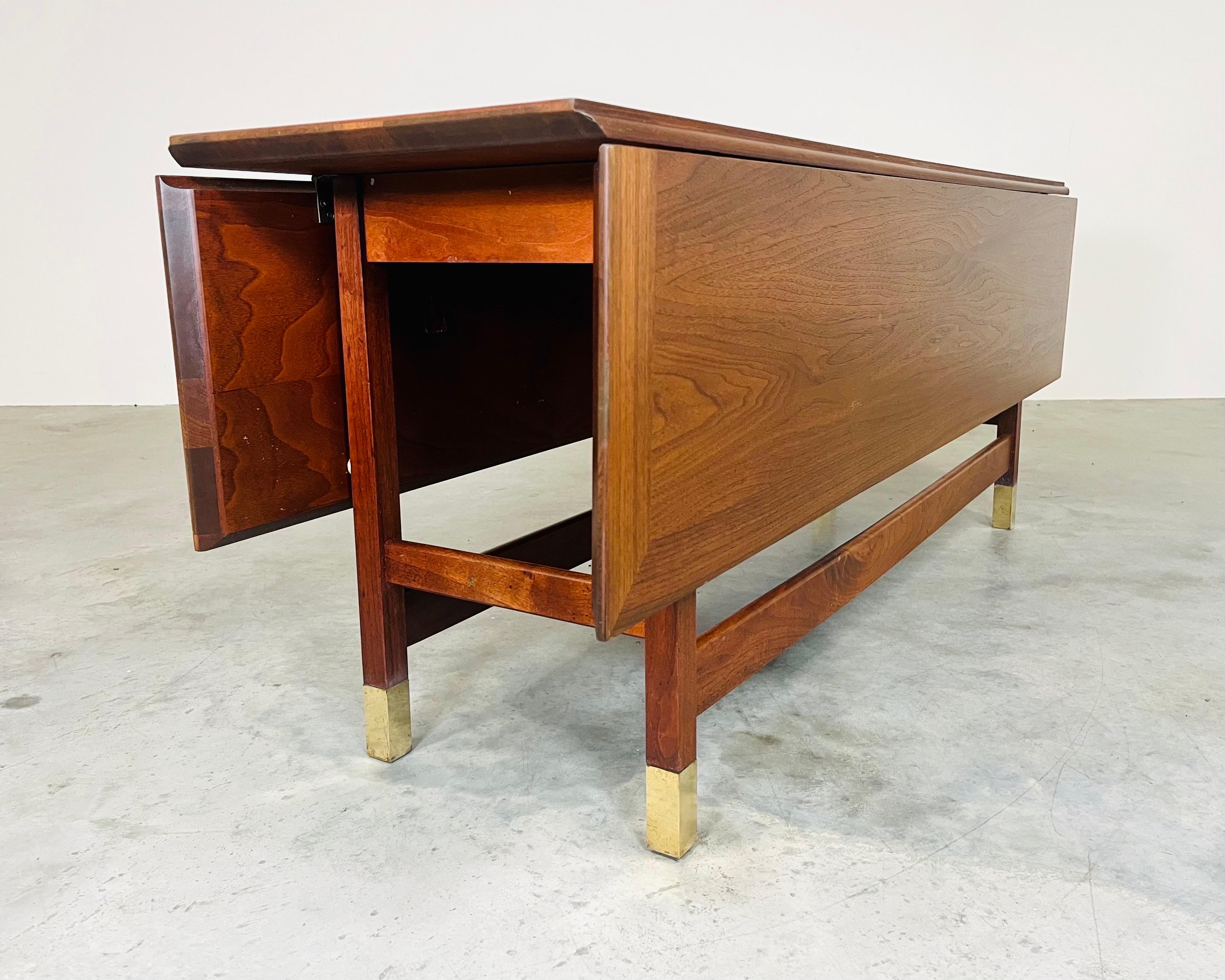 Mid-Century FOUNDERS Coronado Drop-leaf Console Occasional or Serving Table After Harvey Probber 
Having banded walnut top and walnut frame with brass sabot feet. A versatile table that will serve in a private setting or as the center server during