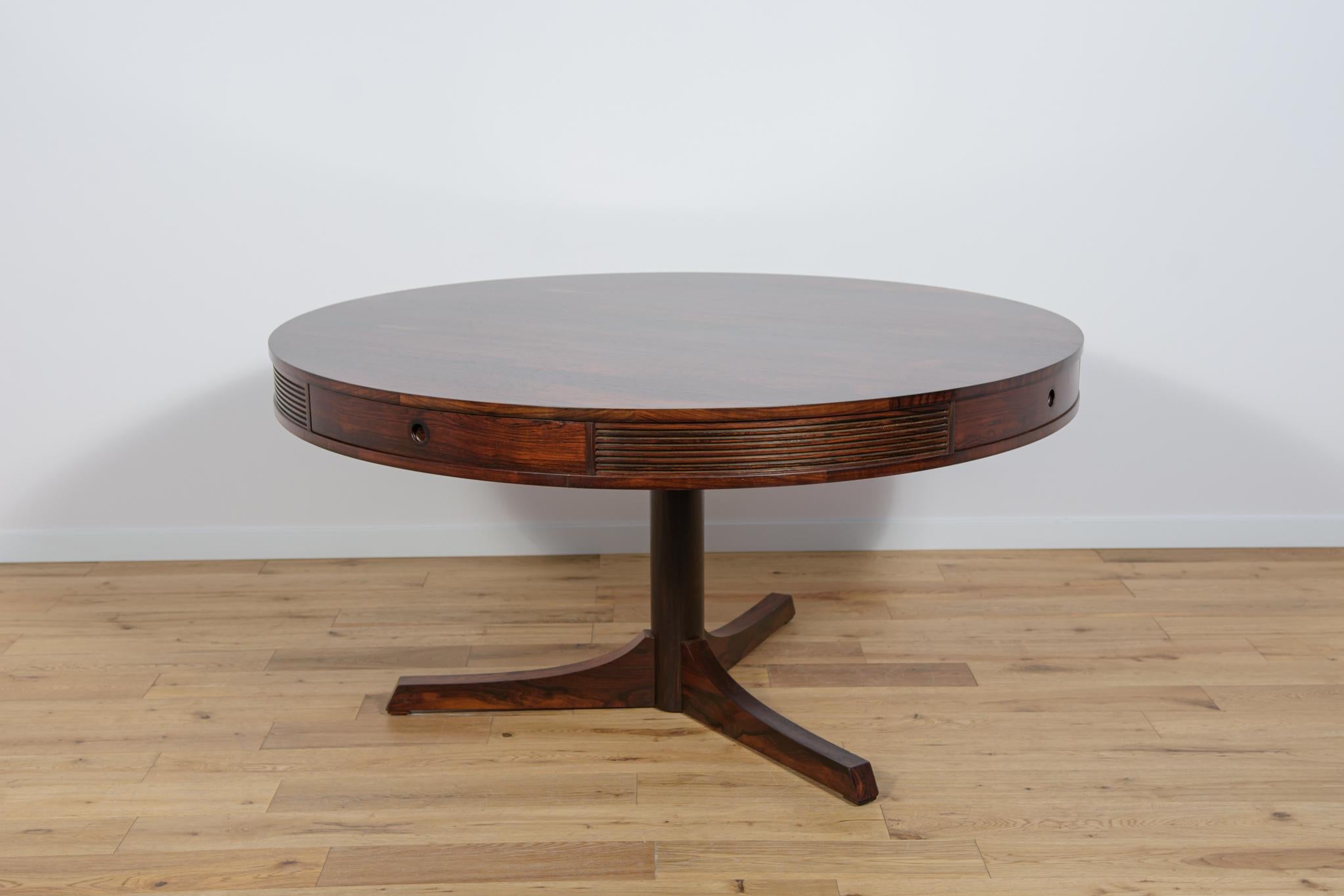 The dining table was designed in 1957 by Robert Heritage and manufactured by Archie Shine in the late 1950s. The table was part of the luxury Bridgeford furniture range, which was sold in english Heals stores during this period. The edge of the